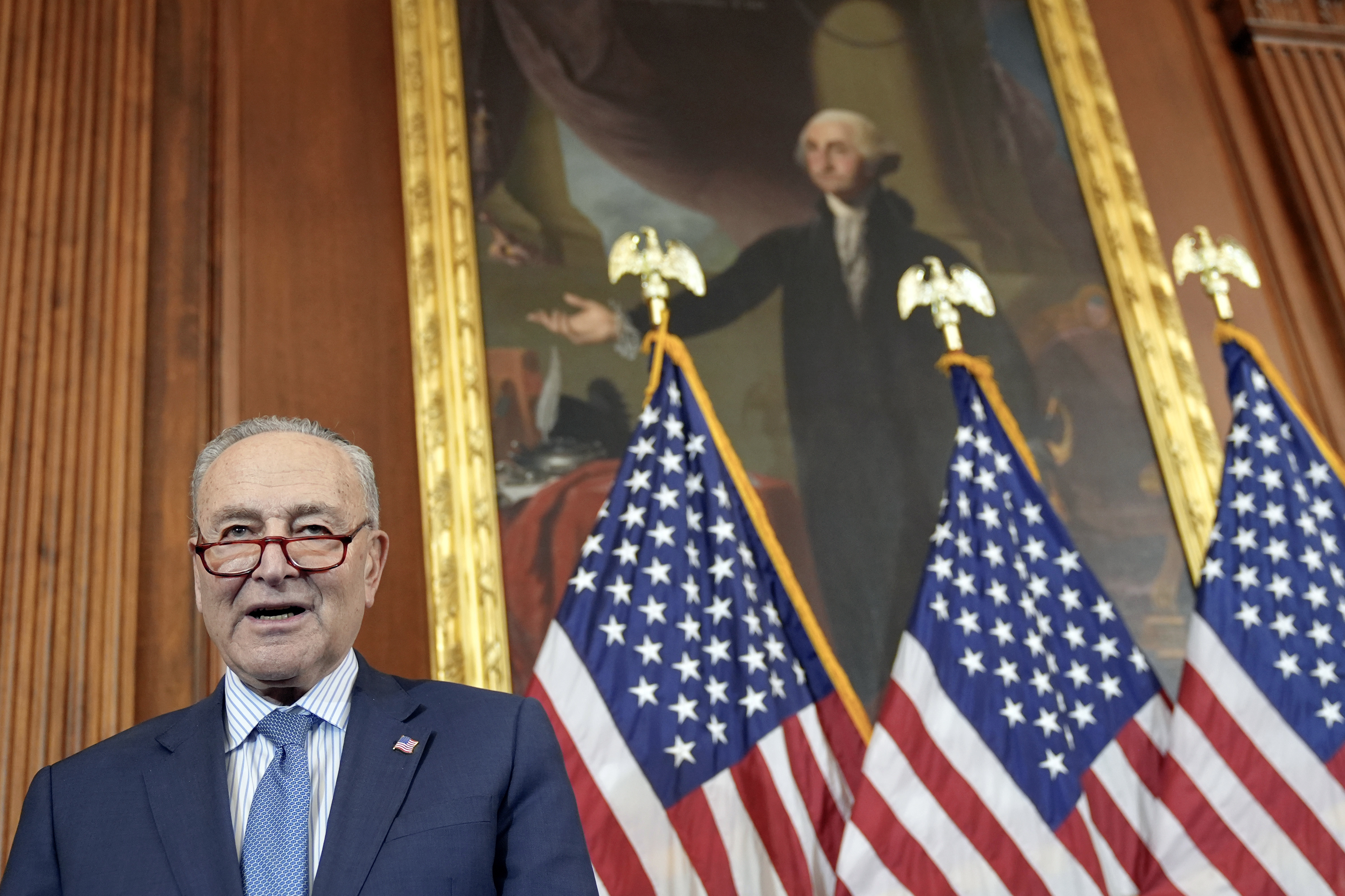 Senate Majority Leader Chuck Schumer, D-N.Y., prays during a U.S. Capitol Hanukkah event with a ceremonial Menorah lighting to commemorate the upcoming eight-day festival of Hanukkah on Capitol Hill Tuesday, Dec. 17, 2024, in Washington. (AP Photo/Mariam Zuhaib)