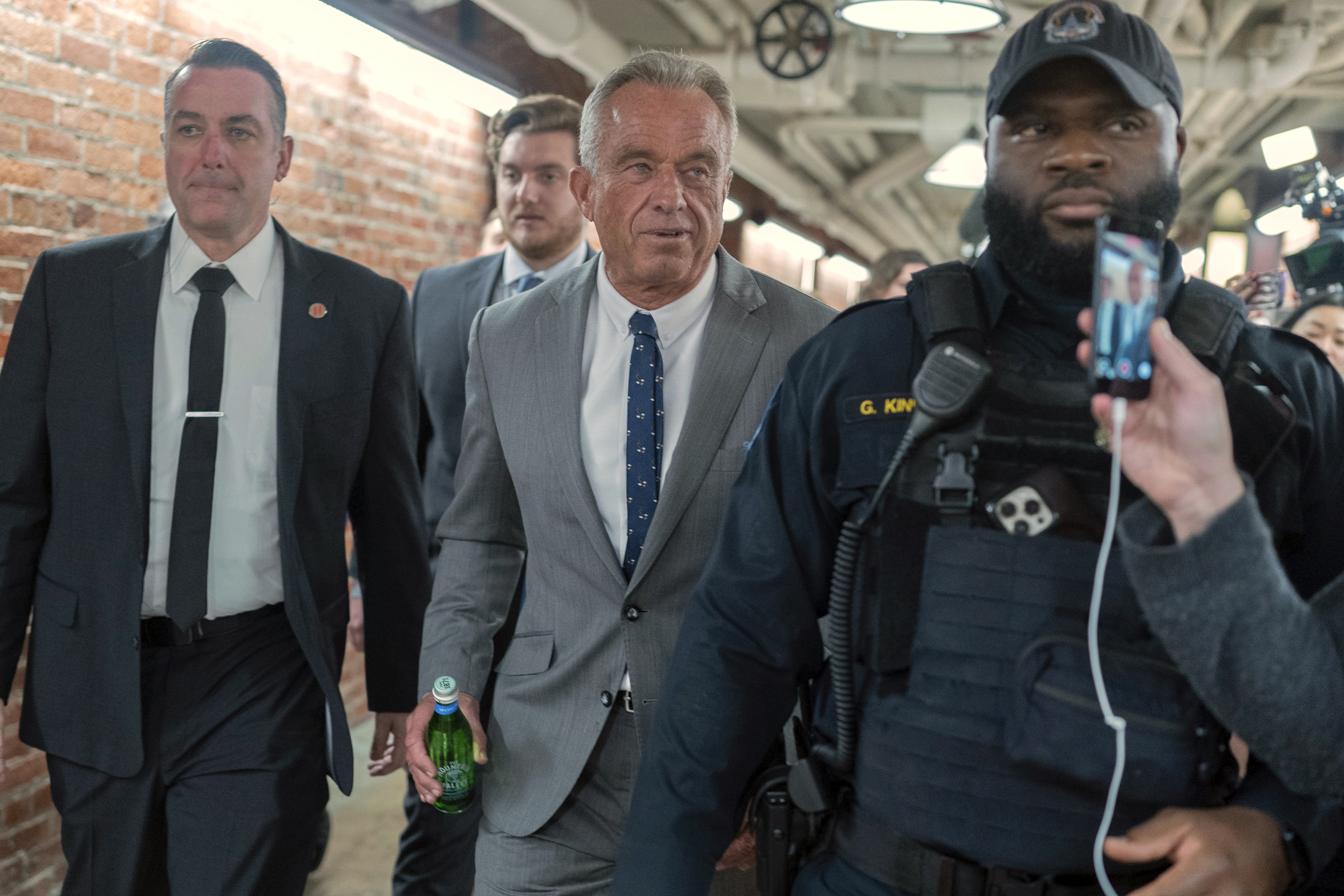 Robert F. Kennedy Jr., President-elect Donald Trump's nominee to be Secretary of Health and Human Services, center, walks to meet with Sen. John Thune, R-S.D. at the Capitol in Washington, Tuesday, Dec. 17, 2024. (AP Photo/Jose Luis Magana)