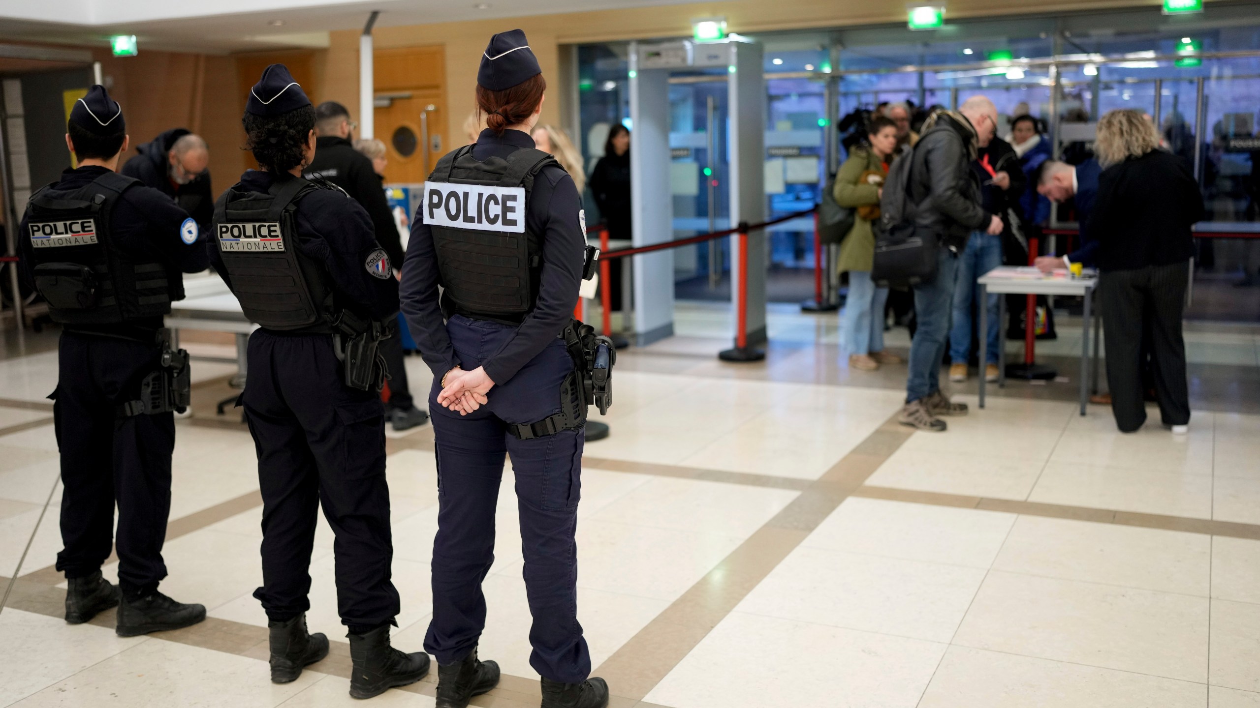 Police officers stand guard inside the courthouse of Avignon during the trial of four dozen men charged with aggravated rape and sexual assault on Gisèle Pelicot, in Avignon, southern France, Thursday, Dec. 19, 2024. (AP Photo/Lewis Joly)