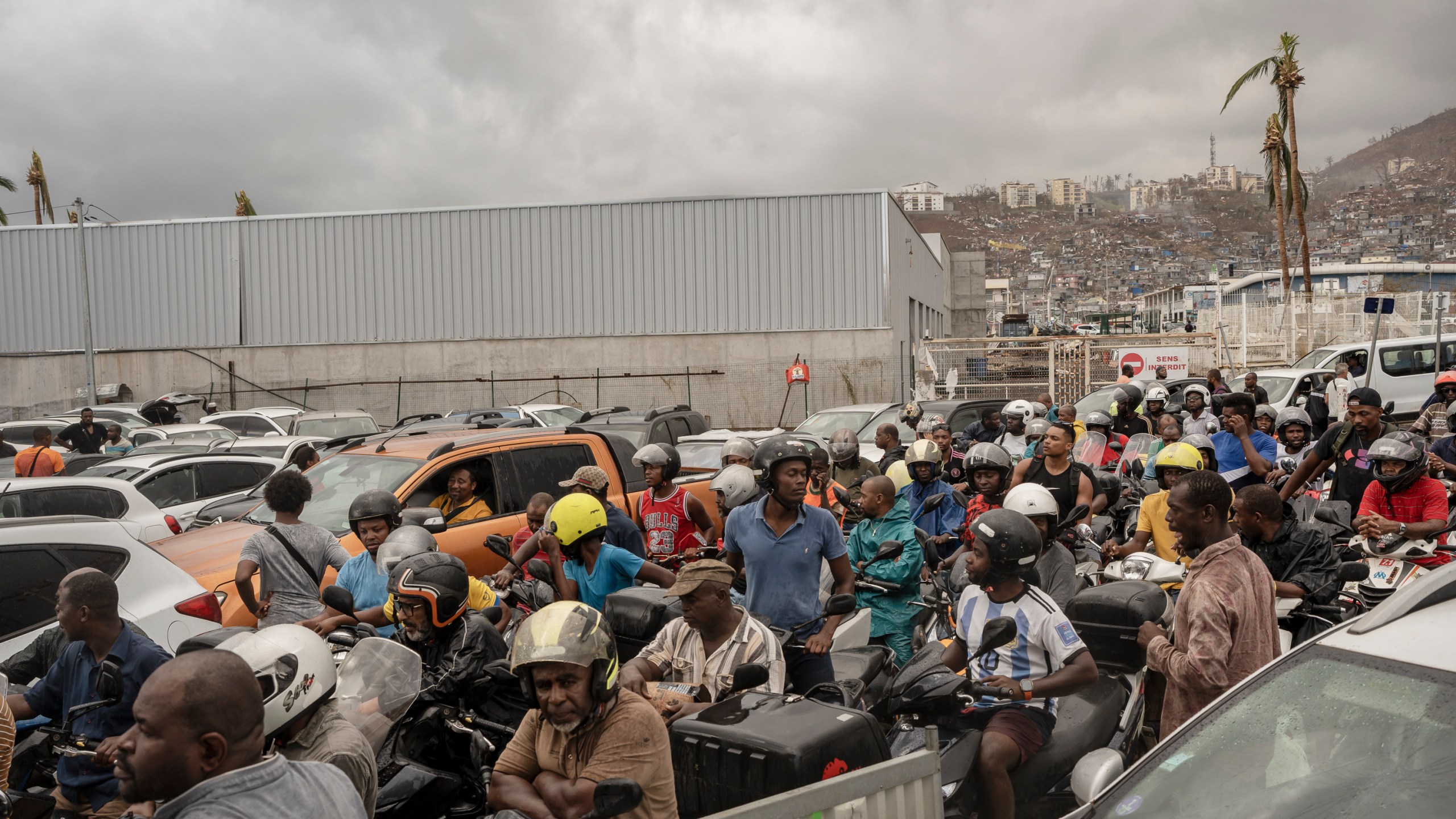 People queue for gas in Mamoudzou, in the French Indian Ocean island of Mayotte, Thursday, Dec. 19, 2024, after Cyclone Chido. (AP Photo/Adrienne Surprenant)