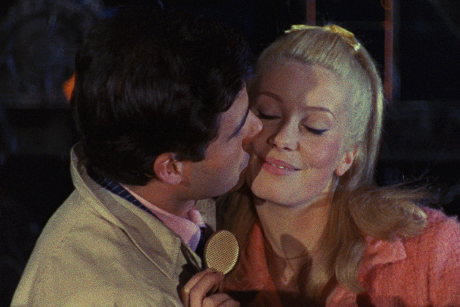 This image released by Janus Films shows Nino Castelnuovo, left, and Catherine Deneuve in a scene from the 1964 French film "The Umbrellas of Cherbourg." (Janus Films via AP)