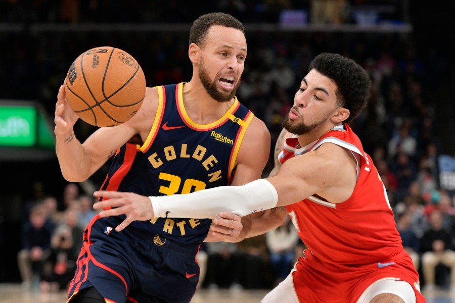 Golden State Warriors guard Stephen Curry (30) drives against Memphis Grizzlies guard Scotty Pippen Jr., right, in the first half of an NBA basketball game Thursday, Dec. 19, 2024, in Memphis, Tenn. (AP Photo/Brandon Dill)