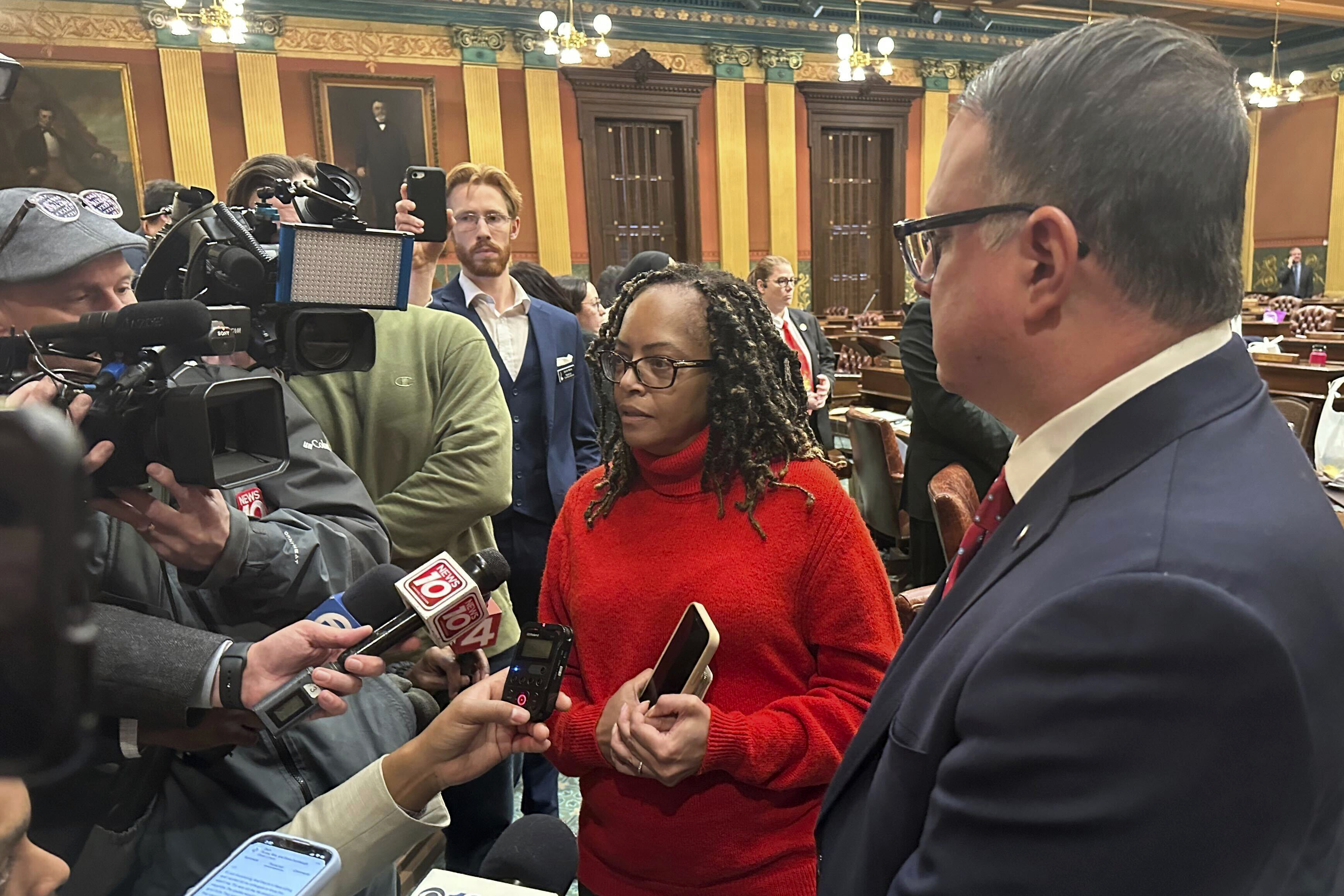 Michigan state Rep. Karen Whitsett, a Detroit Democrat, speaks to reporters in the Michigan House of Representatives in Lansing, Mich., Thursday, Dec. 19, 2024, alongside Republican minority leader Matt Hall. (AP Photo/Isabella Volmert)