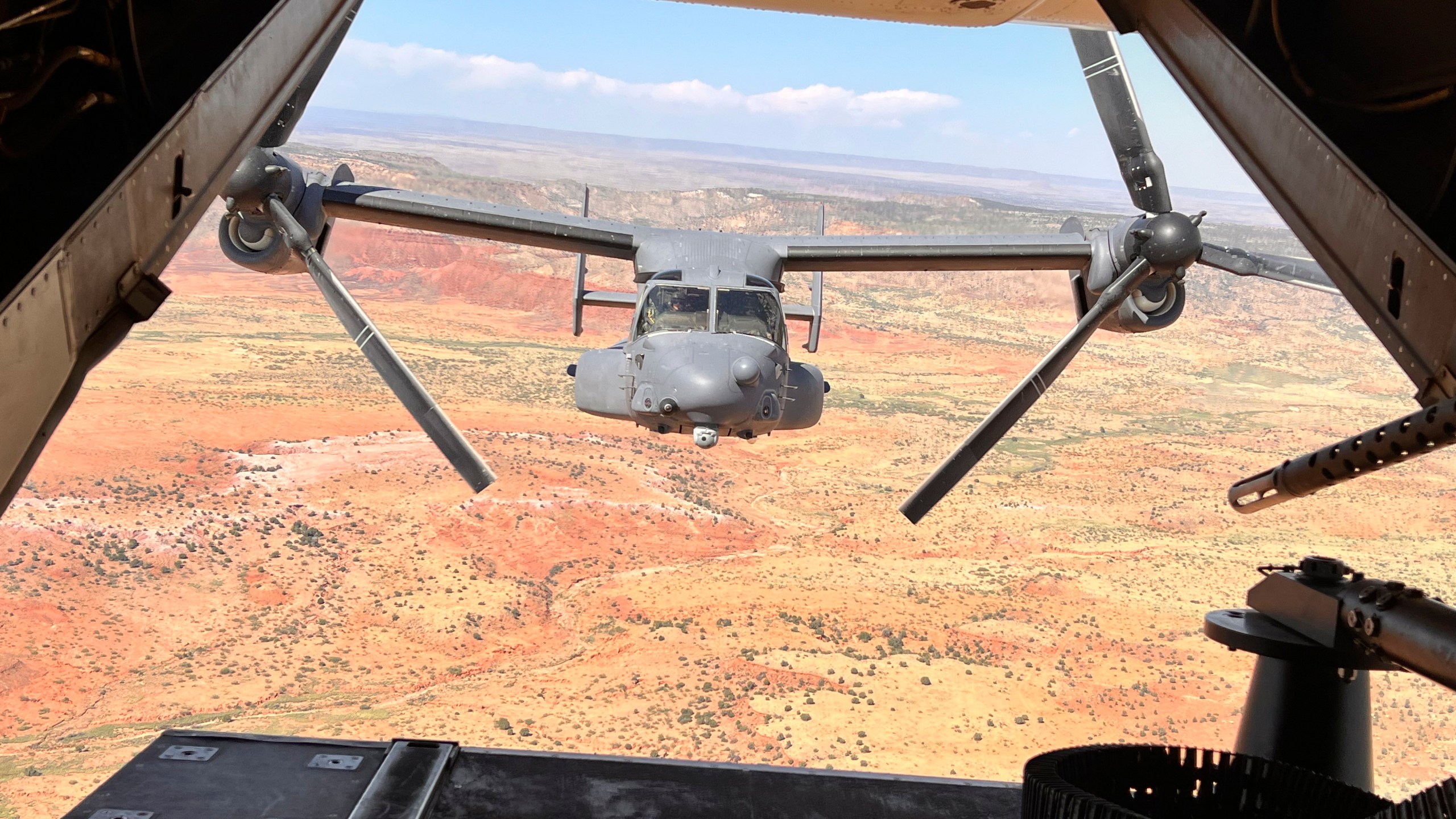 FILE - Two Air Force Special Operations Command CV-22B Ospreys fly low and fast in formation on a training range named the Hornet at Cannon Air Force Base, N.M., Oct. 9, 2024. (AP Photo/Tara Copp, File)