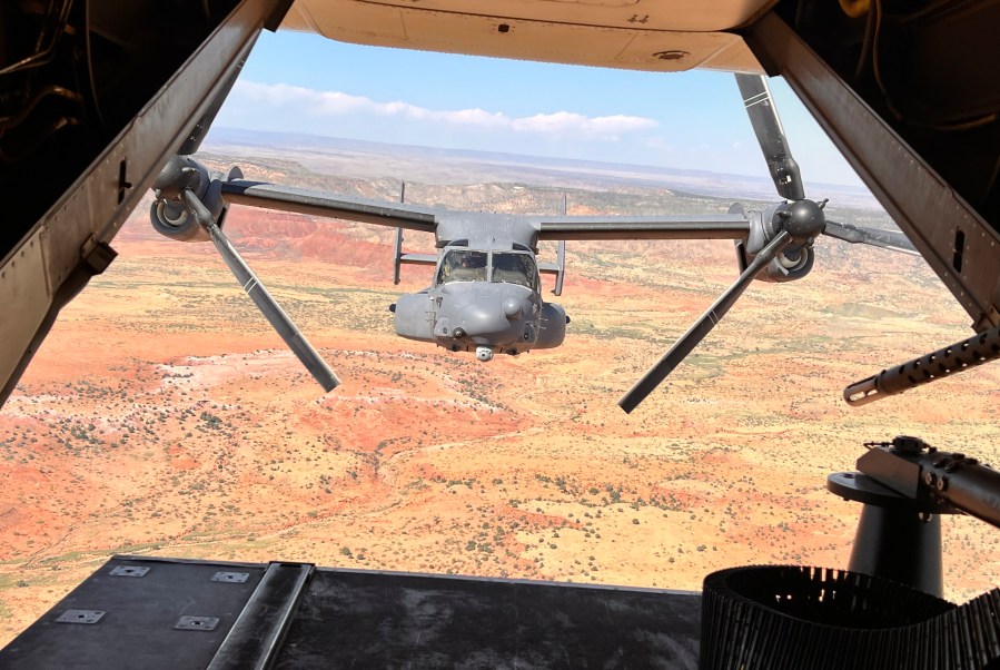 FILE - Two Air Force Special Operations Command CV-22B Ospreys fly low and fast in formation on a training range named the Hornet at Cannon Air Force Base, N.M., Oct. 9, 2024. (AP Photo/Tara Copp, File)