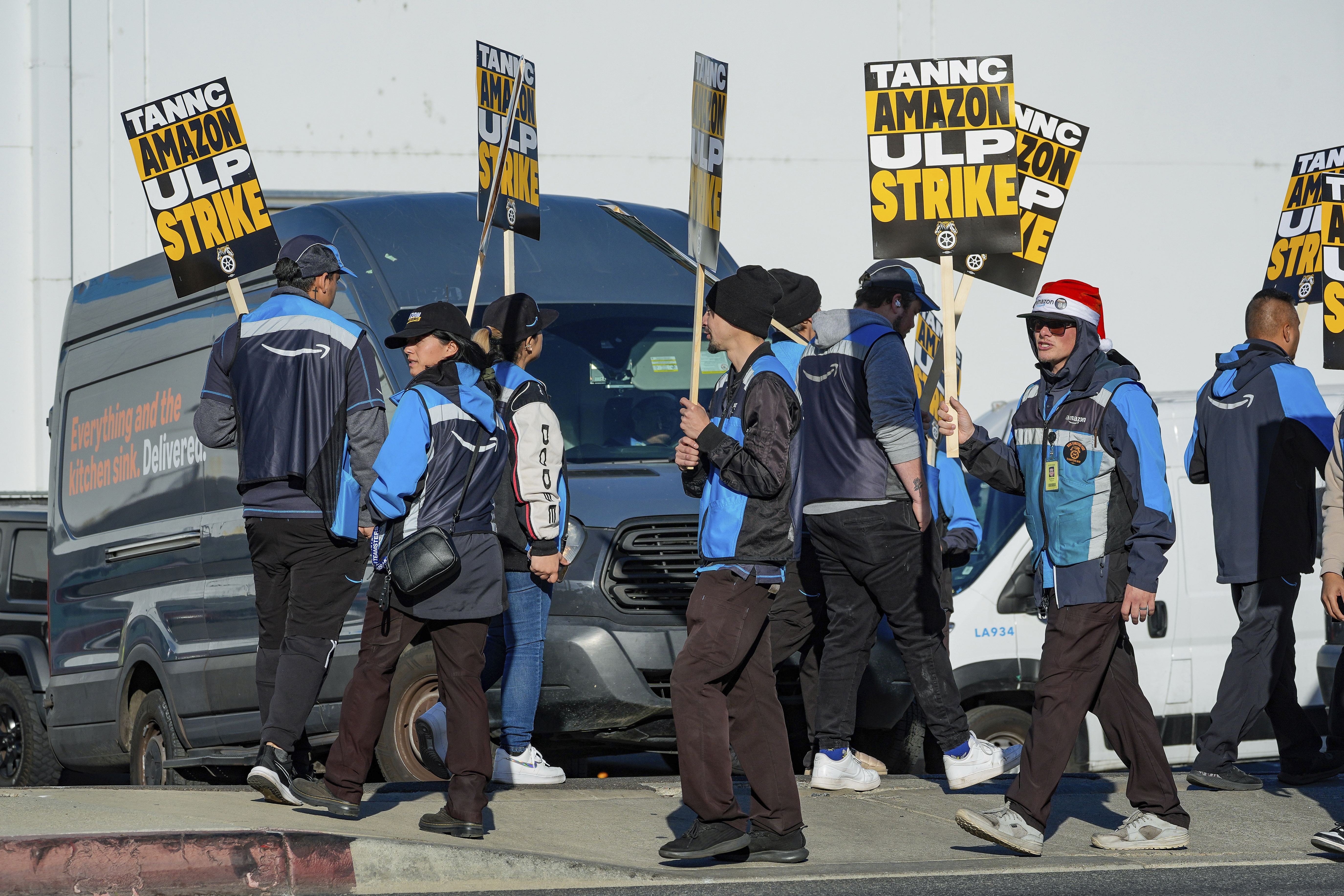 Amazon workers strike outside the gates of an Amazon Fulfillment Center as Teamsters seek labor contract nationwide Thursday, Dec. 19, 2024, in City of Industry, Calif. (AP Photo/Damian Dovarganes)