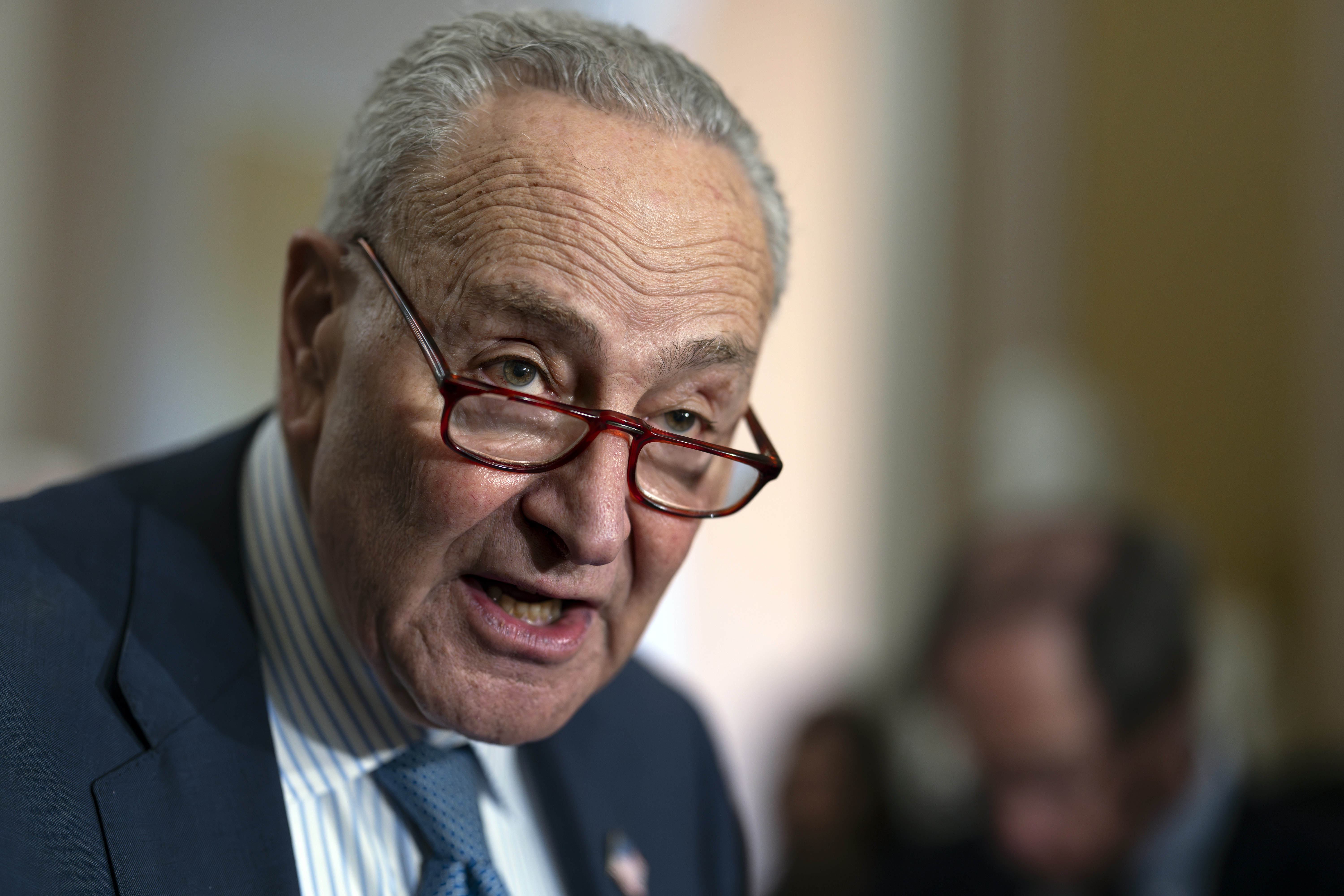 Senate Majority Leader Chuck Schumer, D-N.Y., speaks to reporters following a closed-door strategy session, at the Capitol in Washington, Tuesday, Dec. 17, 2024. Congressional leaders are nearing the unveiling of an agreement that will keep the federal government funded through March 14 and provide more than $100 billion in emergency aid to help states and local communities recover from Hurricanes Helene and Milton, and other natural disasters. (AP Photo/J. Scott Applewhite)