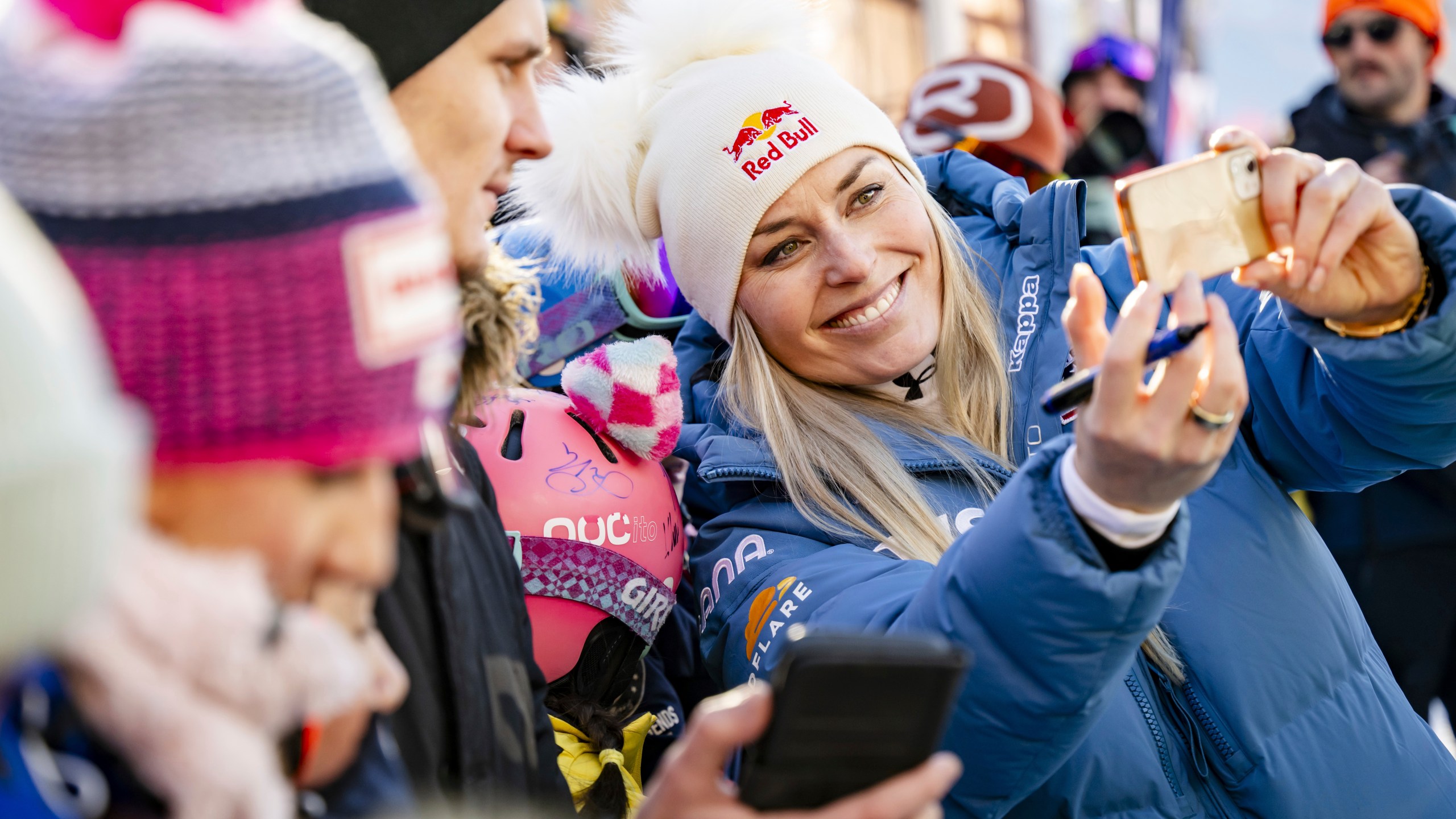 United States' Lindsey Vonn, takes a selfie in the finish area after completing an alpine ski, women's World Cup super G, in St. Moritz, Switzerland, Saturday, Dec. 21, 2024. (Jean-Christophe Bott/Keystone via AP)