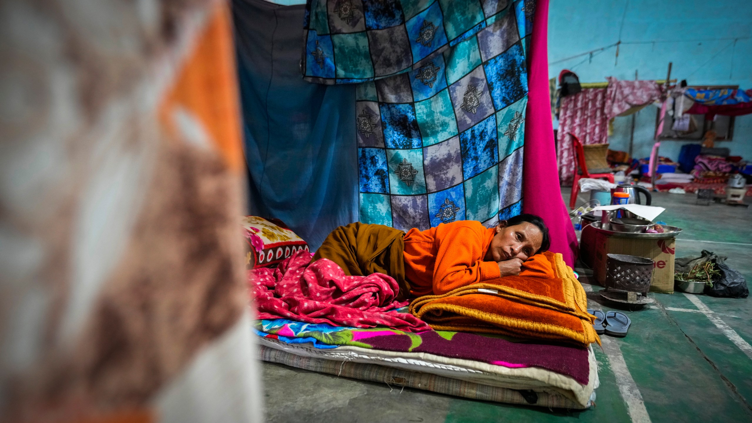 A Meitei woman rests in a relief camp in Imphal, Manipur, Monday, Dec. 16, 2024. (AP Photo/Anupam Nath)