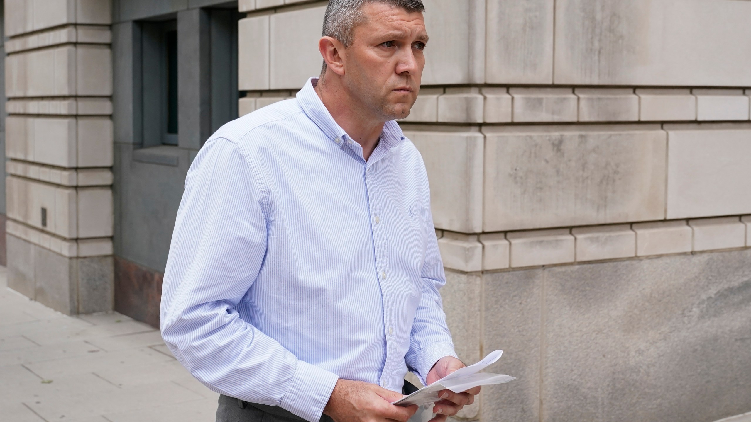 FILE - Washington Metropolitan Police Department Lt. Shane Lamond departs federal court after pleading not guilty to obstruction of justice and other charges, May 19, 2023, in Washington. A trial is underway for a police officer charged with leaking confidential information to Proud Boys leader Enrique Tarrio after the extremist group's members burned a stolen Black Lives Matter banner in the nation's capital. (AP Photo/Patrick Semansky, File)