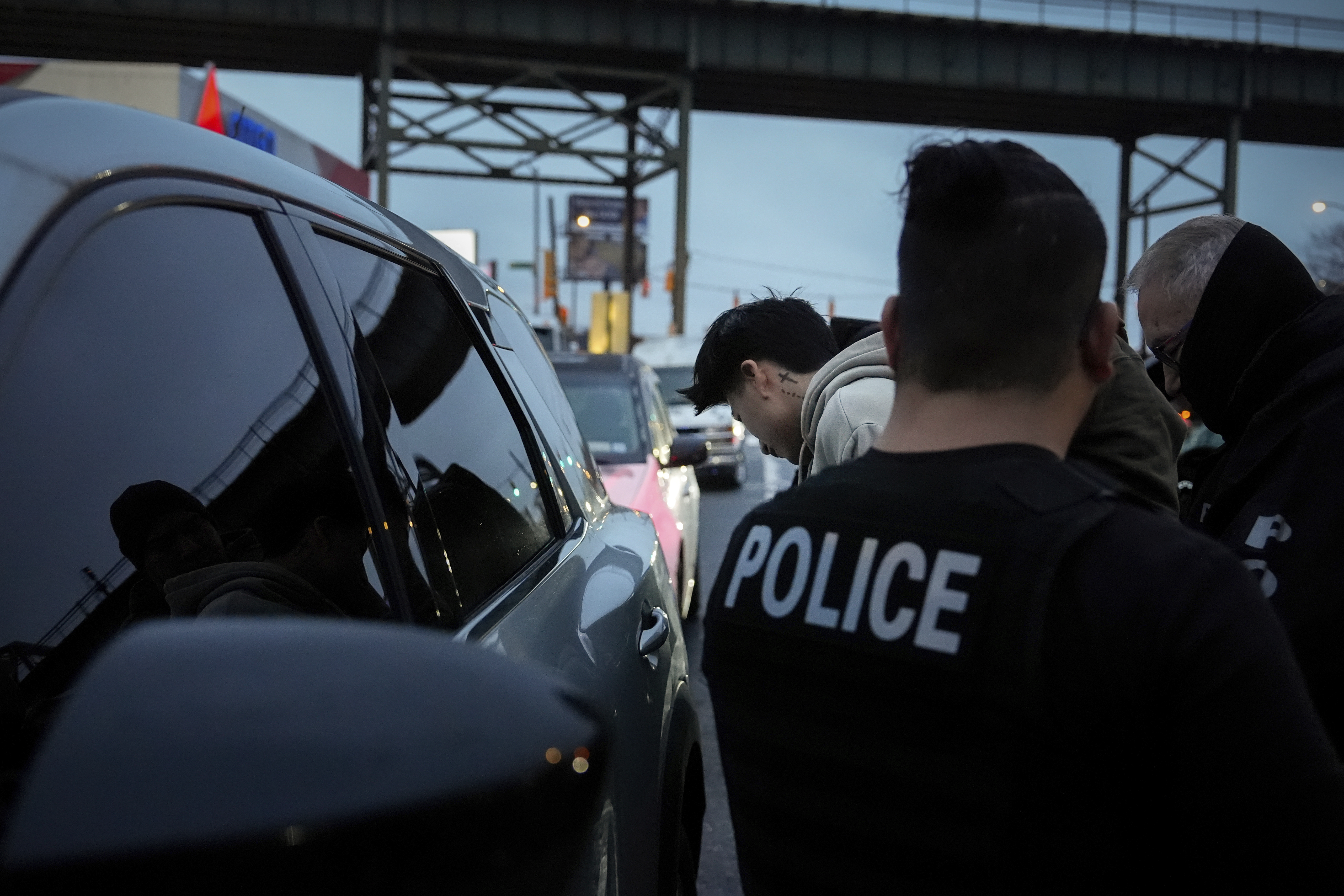 Deportation officers with Enforcement and Removal Operations in U.S. Immigration and Customs Enforcement's New York City field office arrest Wilmer Patricio Medina-Medina during an early morning operation, Tuesday, Dec. 17, 2024, in the Bronx borough of New York. (AP Photo/Julia Demaree Nikhinson)