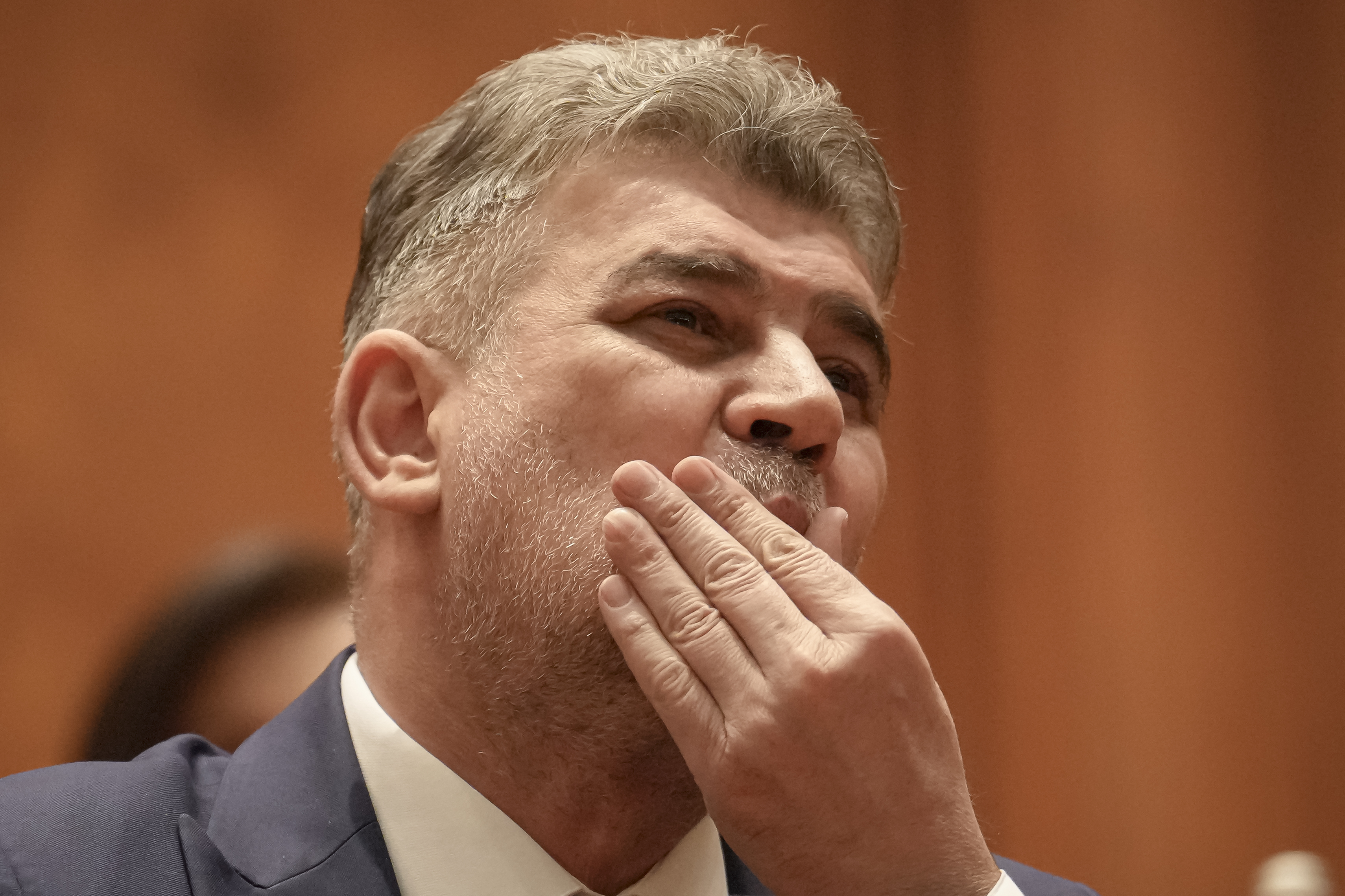 Romanian Prime Minister designate Marcel Ciolacu, the leader of the Social Democratic party, touches his face before a confidence vote for him and his team at the parliament in Bucharest, Romania, Monday, Dec. 23, 2024. (AP Photo/Vadim Ghirda)