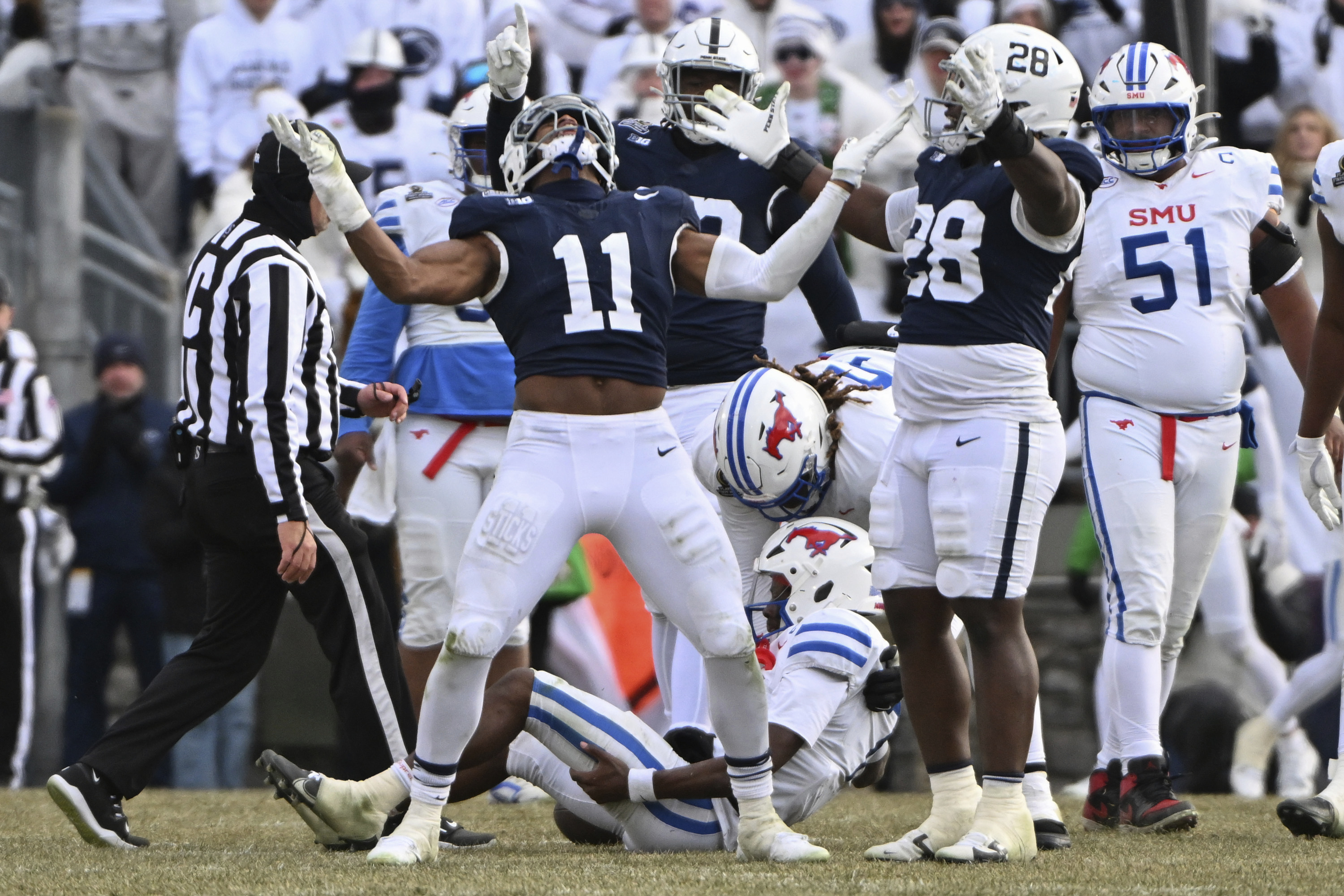 Penn State defensive end Abdul Carter (11) celebrates after sacking SMU quarterback Kevin Jennings during the second half in the first round of the College Football Playoff, Saturday, Dec. 21, 2024, in State College, Pa. (AP Photo/Barry Reeger)