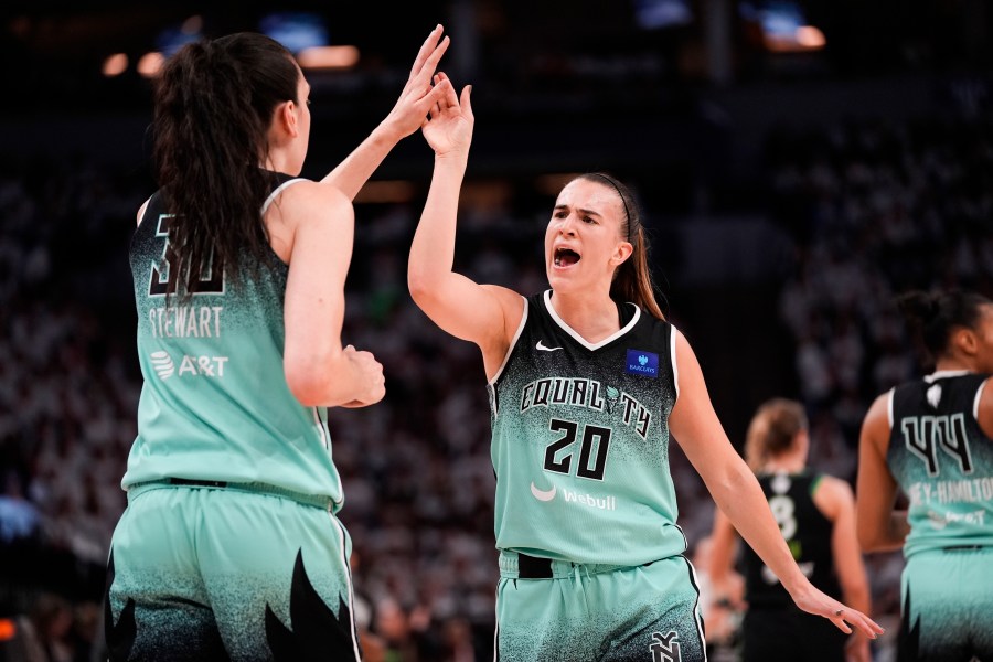 FILE - New York Liberty guard Sabrina Ionescu (20) reacts with forward Breanna Stewart (30) at the end of the first half of Game 4 of a WNBA basketball final playoff series against the Minnesota Lynx, Friday, Oct. 18, 2024, in Minneapolis. (AP Photo/Abbie Parr, File)