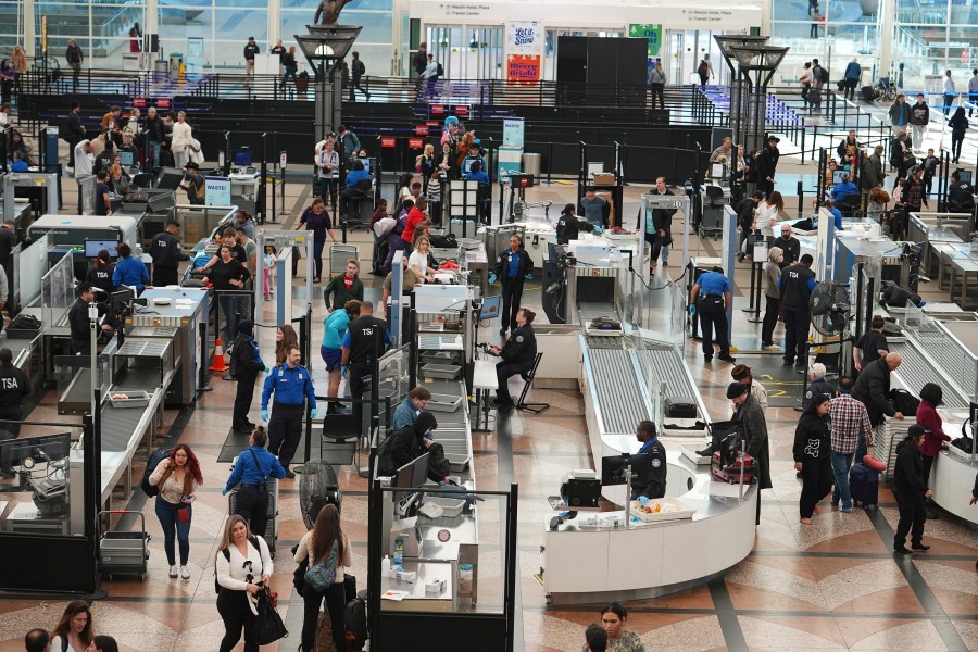 Travelers queue up to pass through the south security checkpoint in the main terminal of Denver International Airport Tuesday, Dec. 24, 2024, in Denver. (AP Photo/David Zalubowski)