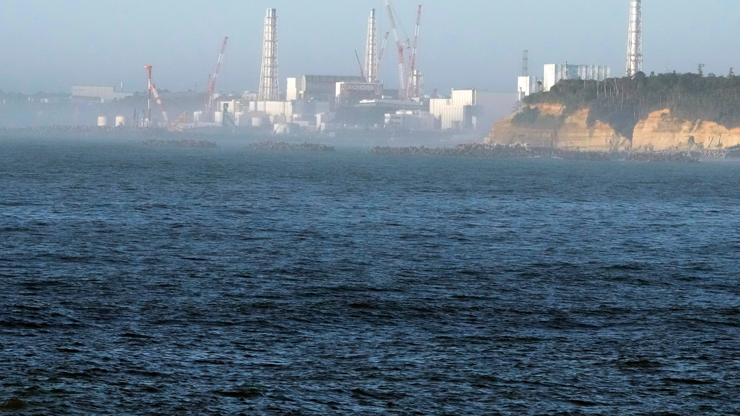 FILE - The Fukushima Daiichi nuclear power plant, damaged by a massive March 11, 2011, earthquake and tsunami, is seen from the nearby Ukedo fishing port in Namie town, northeastern Japan, Thursday, Aug. 24, 2023. (AP Photo/Eugene Hoshiko, File)