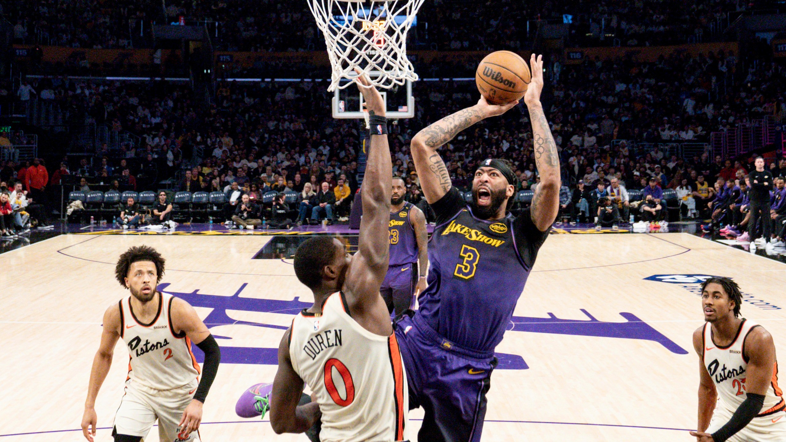 Los Angeles Lakers forward Anthony Davis (3) shoots over Detroit Pistons center Jalen Duren (0) during the second half of an NBA basketball game in Los Angeles, Monday, Dec. 23, 2024. (AP Photo/Eric Thayer)