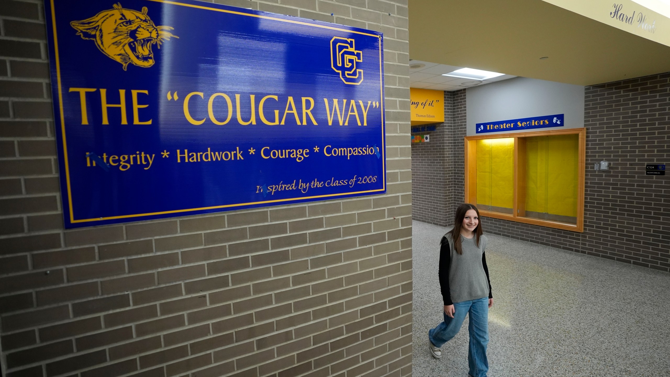 Makenzie Gilkison walks down the hallway at Greenfield Central High School, Tuesday, Dec. 17, 2024, in Greenfield, Ind. (AP Photo/Darron Cummings)