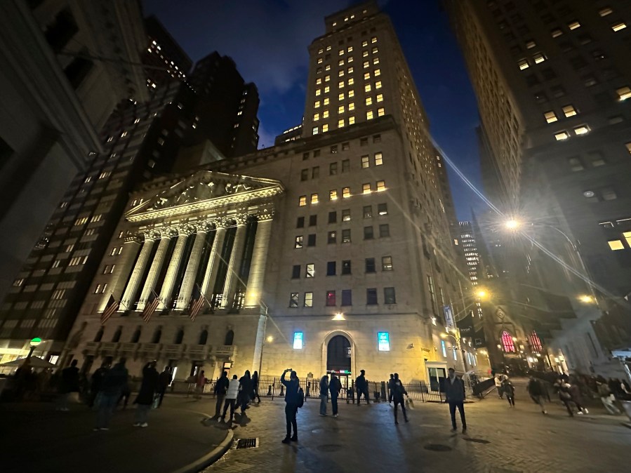 FILE - People walk past the New York Stock Exchange on Nov. 26 2024. (AP Photo/Peter Morgan, File)