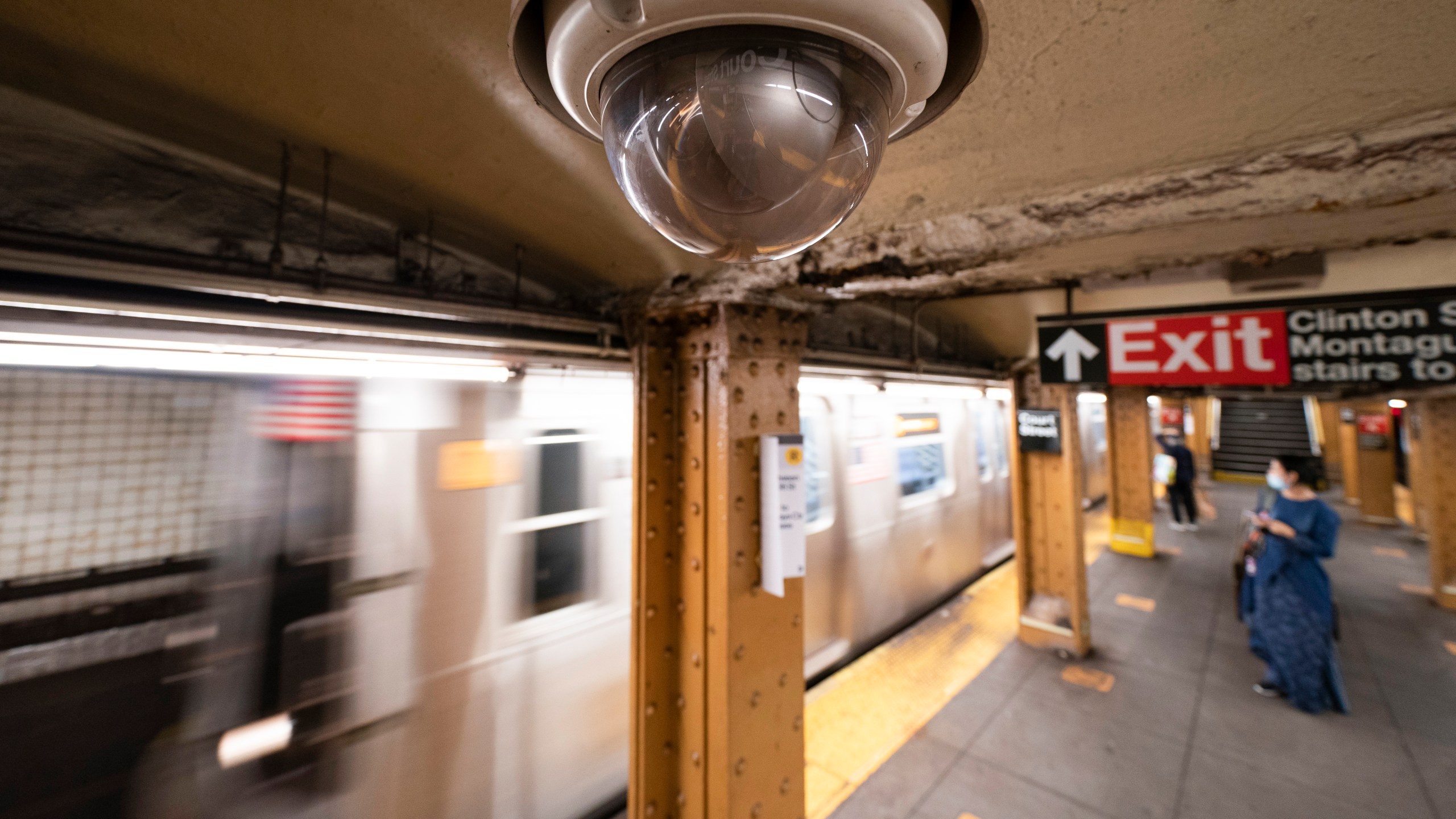 FILE - A video surveillance camera hangs from the ceiling above a subway platform, Oct. 7, 2020, in the Brooklyn borough of New York. (AP Photo/Mark Lennihan, File)