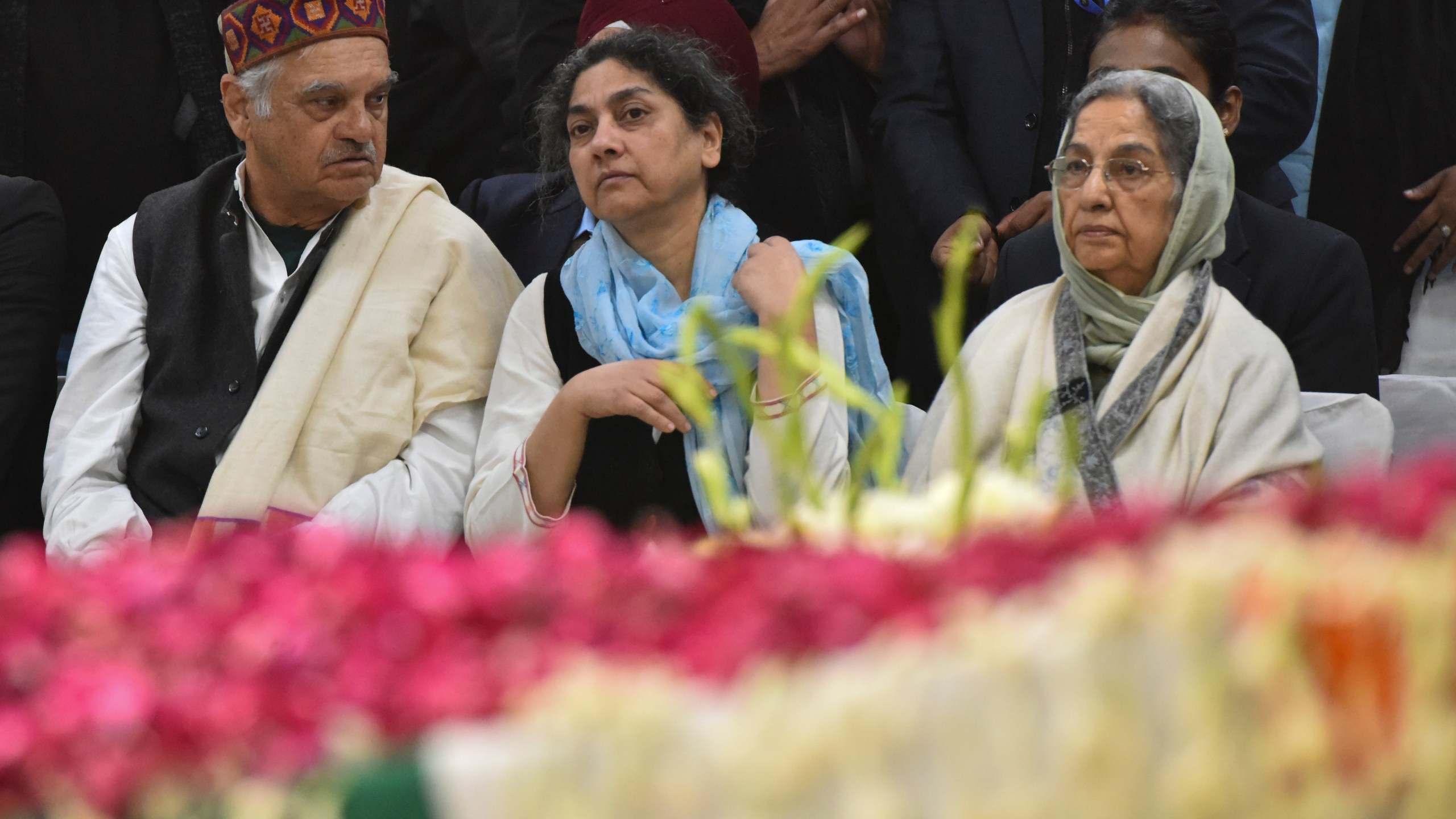 Gursharan Kaur, right, wife of former Indian Prime Minister Manmohan Singh, sits with others next to the casket of her late husband at Congress party headquarters in New Delhi, India, Saturday, Dec. 28, 2024. (AP Photo)