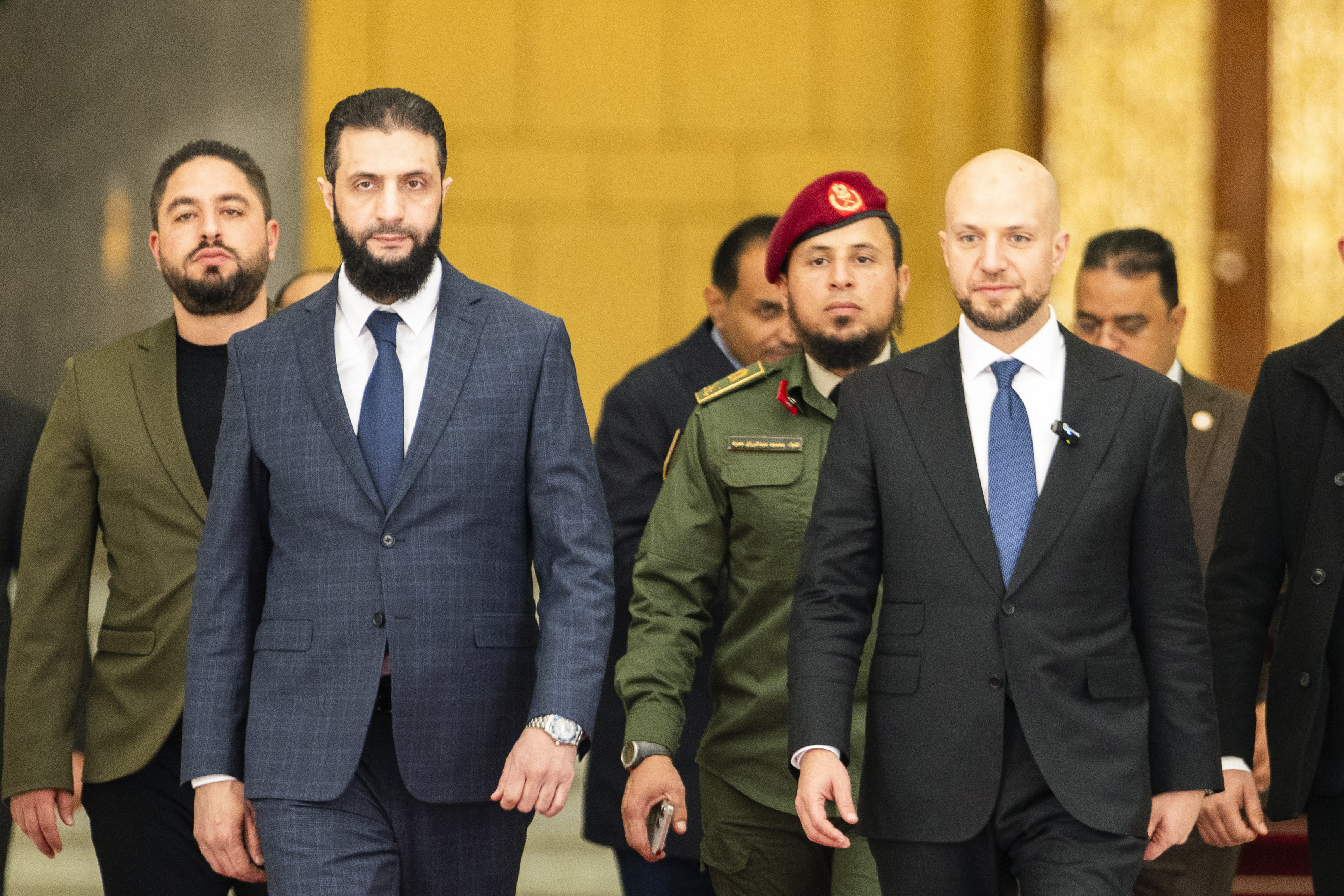 Syria's de facto leader Ahmad al-Sharaa, oreground left, formerly known as Abu Mohammed al-Golani, meets with Walid Ellafi, right, Libyan minister of state for communication and political affairs, in the presidential palace in Damascus, Syria, Saturday, Dec. 28, 2024. (AP Photo/Mosa'ab Elshamy)