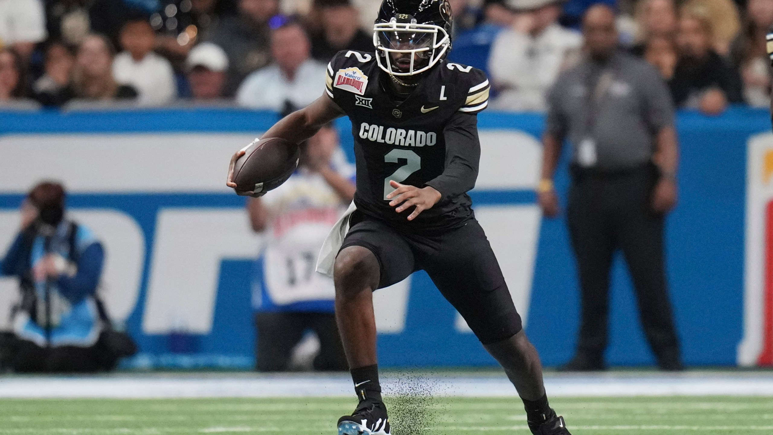 Colorado quarterback Shedeur Sanders (2) scramble for yardage against BYU during the first half of the Alamo Bowl NCAA college football game, Saturday, Dec. 28, 2024, in San Antonio. (AP Photo/Eric Gay)