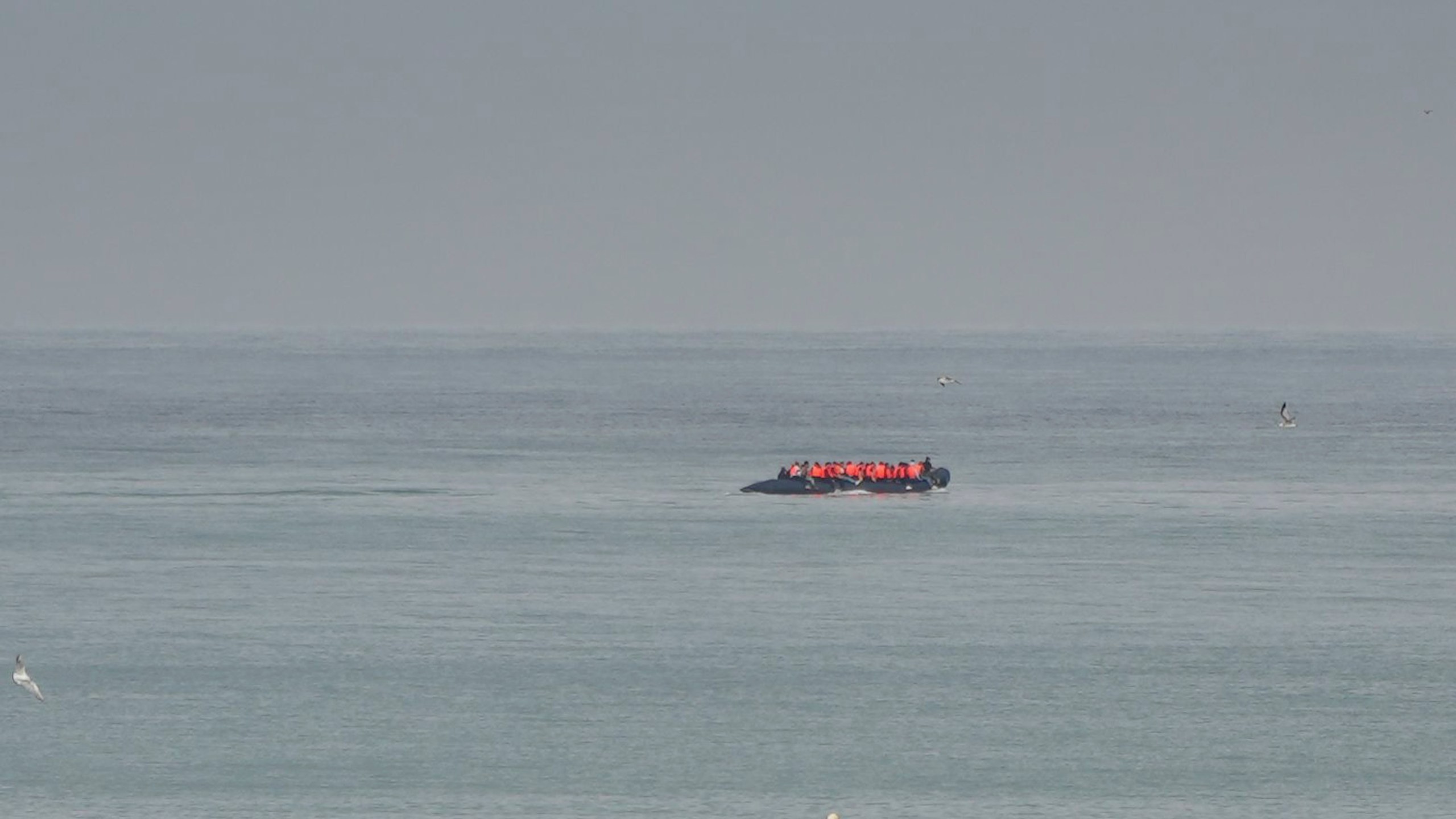 FILE- A boat thought to be with migrants is seen in the sea near the Wimereux beach, France, on Sept. 4, 2024. (AP Photo/Nicolas Garriga, File)