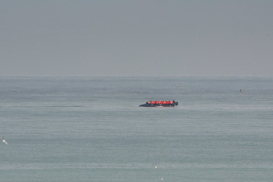 FILE- A boat thought to be with migrants is seen in the sea near the Wimereux beach, France, on Sept. 4, 2024. (AP Photo/Nicolas Garriga, File)