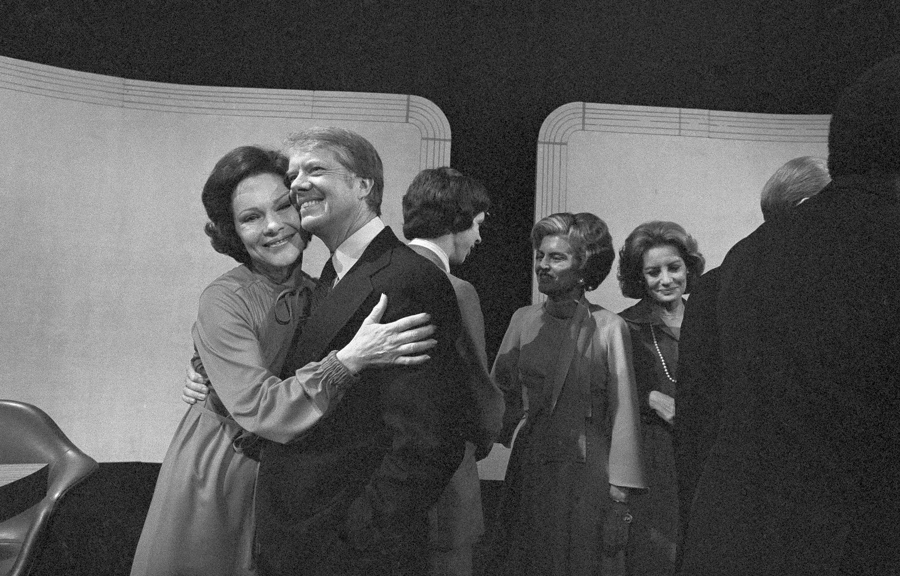 FILE - Democratic presidential candidate Jimmy Carter gets a hug from his wife, Rosalynn, after the third presidential debate on Oct. 22, 1976, Williamsburg, Va. (AP Photo, File)