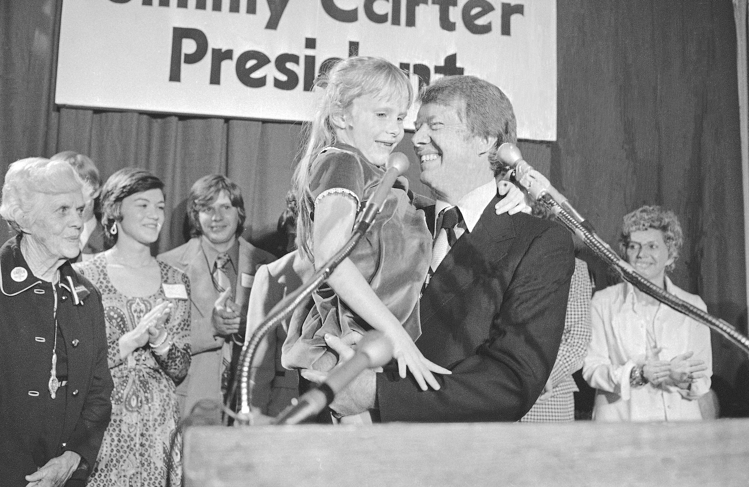 FILE - Georgia Gov. Jimmy Carter holds his daughter, Amy, just after he made his official announcement that he would seek the Democratic nomination for presidency on Dec. 13, 1974, in Atlanta. (AP Photo, File)