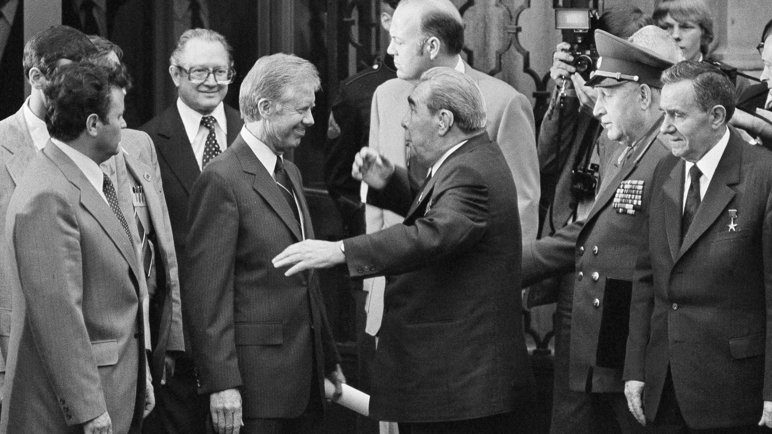 FILE - President Jimmy Carter, left center, smiles as Soviet President and Party Chief Leonid Brezhnev, center, jokes around him outside the U.S. Embassy in Vienna, Austria, June 16, 1979, before they head for their second round of talks prior to the signing of the SALT II Treaty. (AP Photo, File)