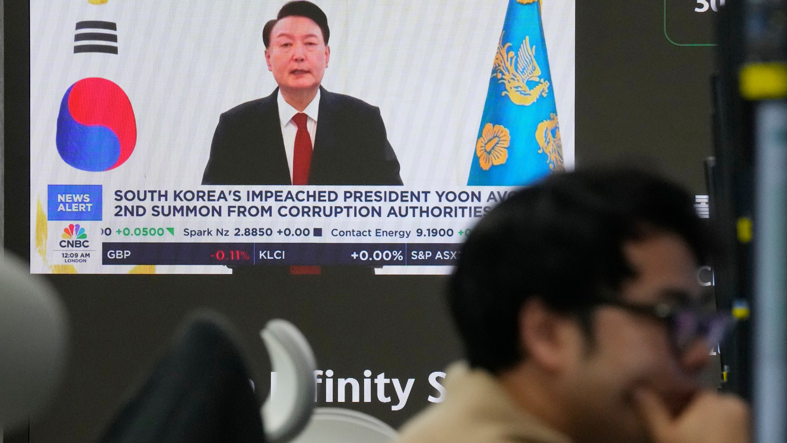 A TV screen shows a file image of South Korean President Yoon Suk Yeol, being broadcast at the KEB Hana Bank headquarters in Seoul, South Korea, Thursday, Dec. 26, 2024. (AP Photo/Ahn Young-joon)