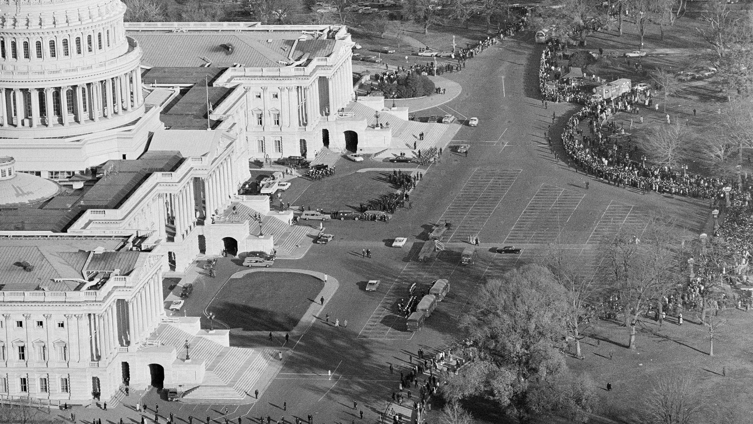 FILE - This is an aerial view of the Capitol as thousands and thousands of people line up in freezing weather to file past the casket of John F. Kennedy in the rotunda where his body lies in state, Nov. 25, 1963. (AP Photo/Bob Schutz, File)