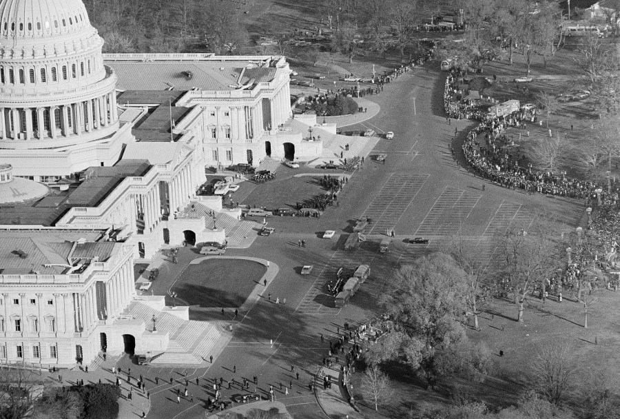 FILE - This is an aerial view of the Capitol as thousands and thousands of people line up in freezing weather to file past the casket of John F. Kennedy in the rotunda where his body lies in state, Nov. 25, 1963. (AP Photo/Bob Schutz, File)