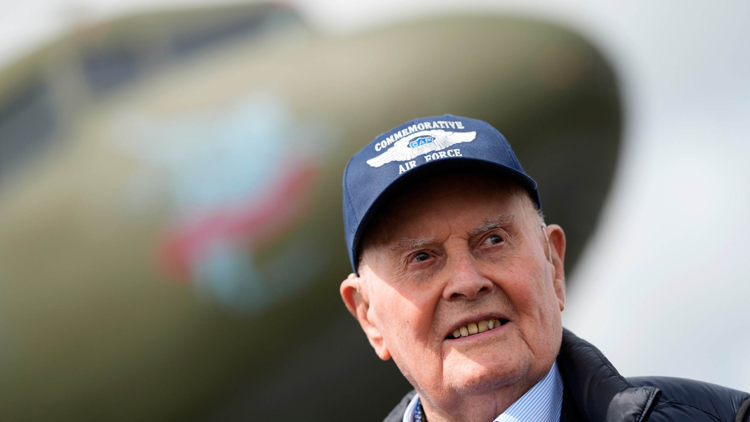 FILE - Veteran Royal Air Force pilot Colin Bell, a 103-year-old former Mosquito pilot who also flew many aircraft across the Atlantic during the war, poses for the media next to a Douglas C-47 Skytrain aircraft, at North Weald airport in North Weald Bassett, England, Thursday, May 16, 2024. (AP Photo/Alastair Grant, File)