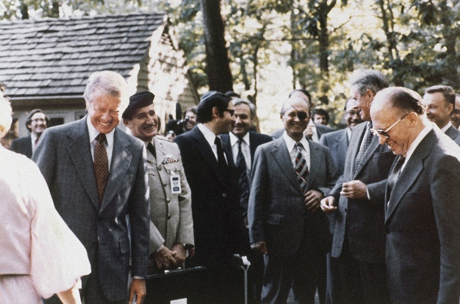 FILE - President Jimmy Carter, Israeli Premier Menachem Begin and Egyptian President Anwar Sadat gather with their aides during discussions on Middle East problems at Camp David, Md., in September 1978. (AP Photo, File)