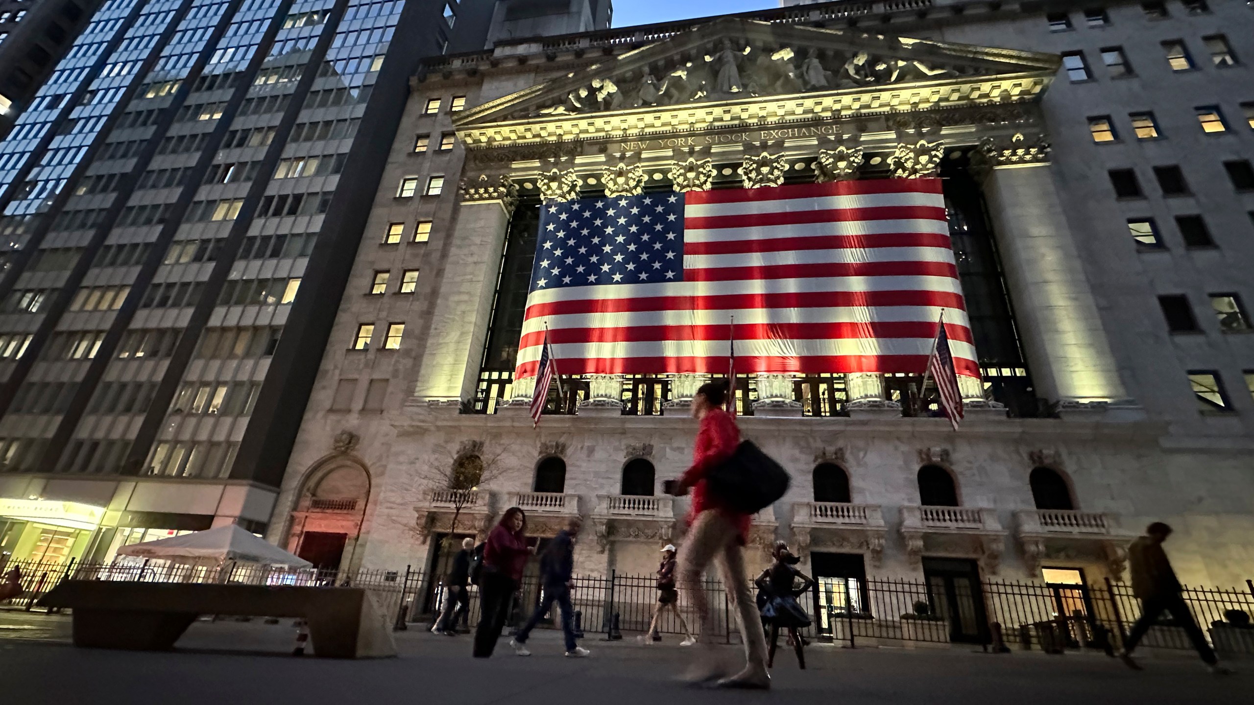 FILE - People pass the New York Stock Exchange on Nov. 5, 2024, in New York. (AP Photo/Peter Morgan, File)