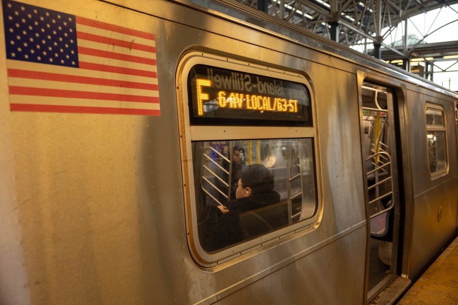 FILE - Commuters sit on the F train at the Coney Island-Stillwell Avenue Station, Thursday, Dec. 26, 2024, in New York. (AP Photo/Yuki Iwamura, File)