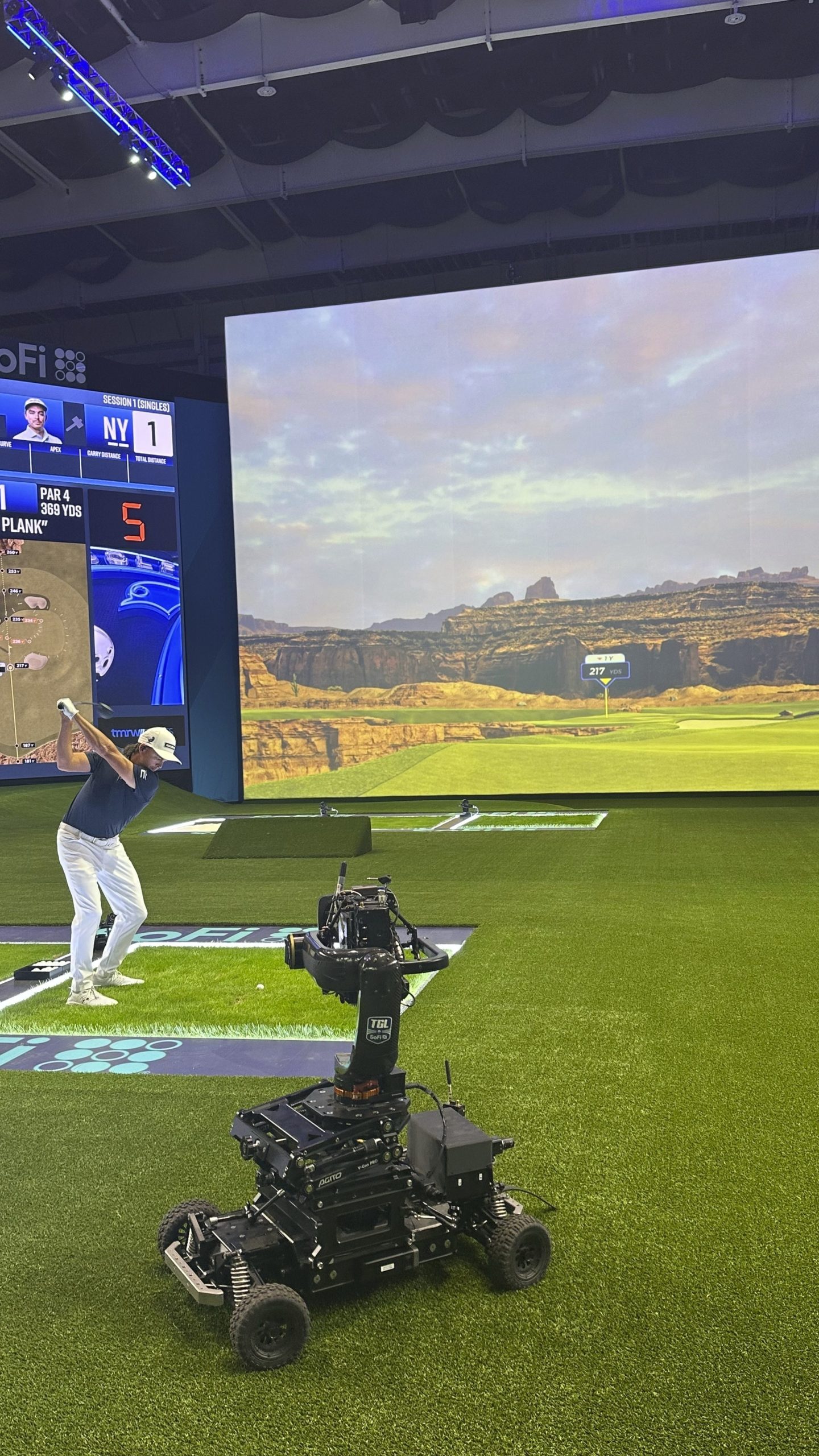 Rickie Fowler hits into the massive simulator screen at the SoFi Center in Palm Beach Gardens, Fla, on Dec. 18, 2024. The 250,000-square-foot complex holds the new TMRW Golf League co-owned by Tiger Woods and Rory McIlroy. The first match is Jan. 7, 2025 in prime time on ESPN. (AP Photo/Doug Ferguson)