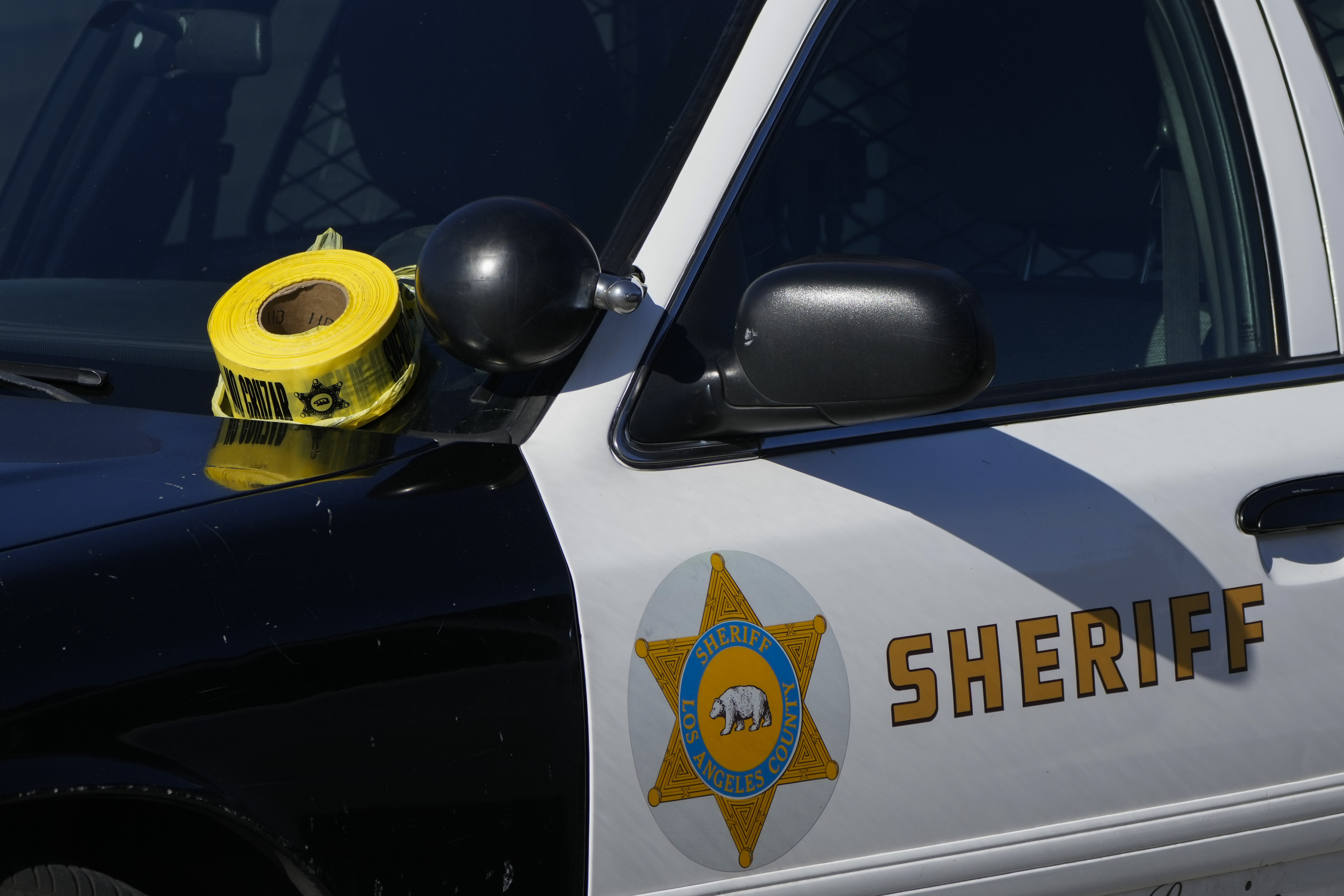 FILE - A roll of police tape is left on the windshield of a Los Angeles County sheriff's vehicle in the parking lot of its training academy in Whittier, Calif., Nov. 16, 2022. (AP Photo/Jae C. Hong, File)