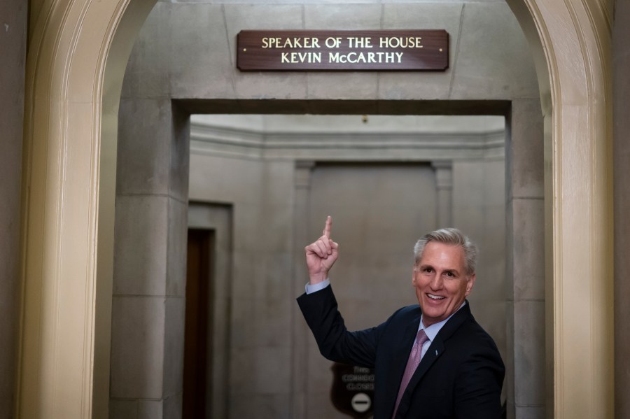 FILE - Then-House Speaker Kevin McCarthy of Calif., gestures towards the newly installed nameplate at his office after he was sworn in as speaker of the 118th Congress in Washington, early Saturday, Jan. 7, 2023. (AP Photo/ Matt Rourke, File)