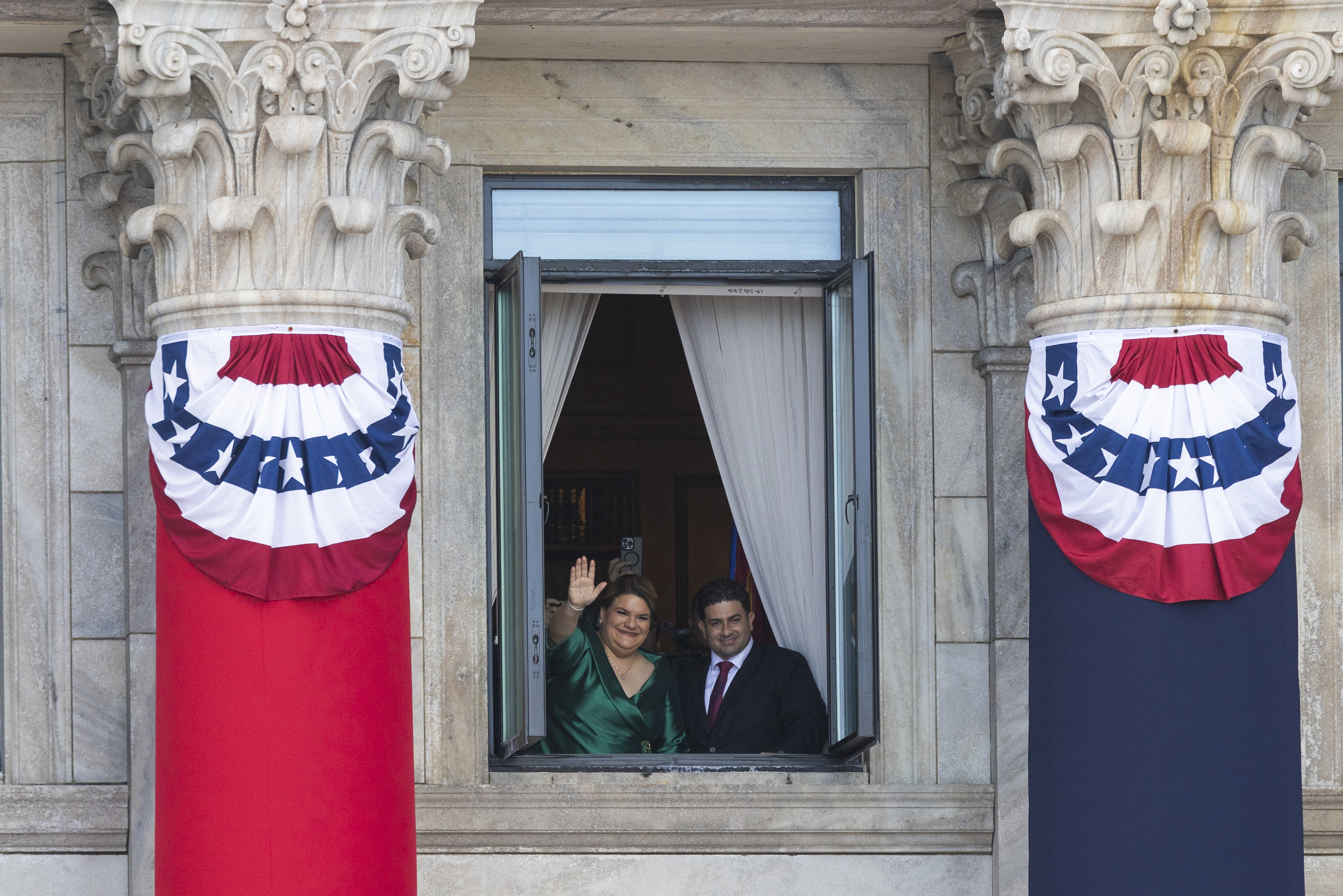 Jenniffer Gonzalez Colon waves next to her husband Jose Yovin Vargas, after her swearing-in ceremony as governor at the Capitol in San Juan, Puerto Rico, Thursday, Jan. 2, 2025. (AP Photo/Alejandro Granadillo)