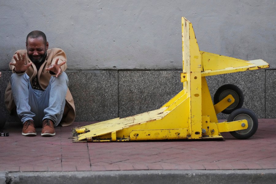 Jovon Bell from New York, who said he was injured in the New Year's attack, reacts near a temporary barriers set up in the French Quarter, Thursday, Jan. 2, 2025, in New Orleans. (AP Photo/George Walker IV)