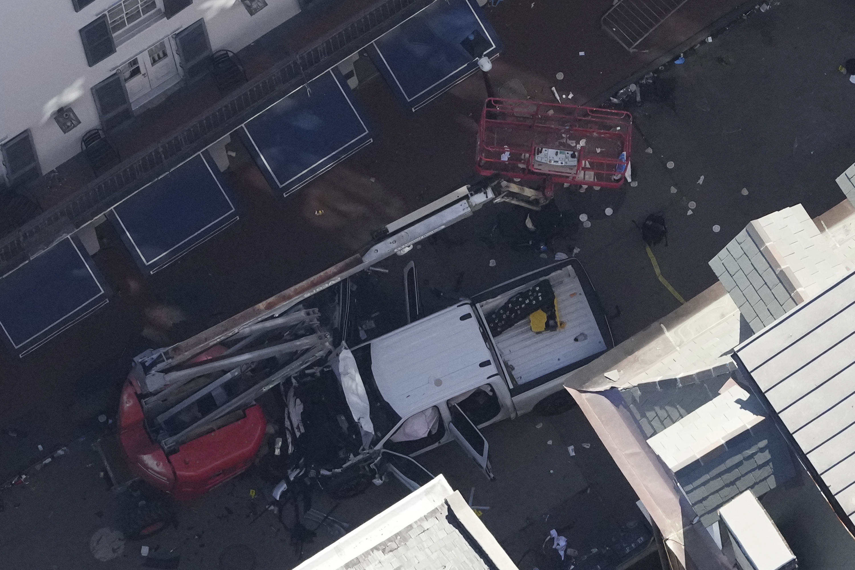 Investigators work the scene after a person drove a vehicle into a crowd earlier on Canal and Bourbon Street in New Orleans, Wednesday, Jan. 1, 2025. (AP Photo/Gerald Herbert)