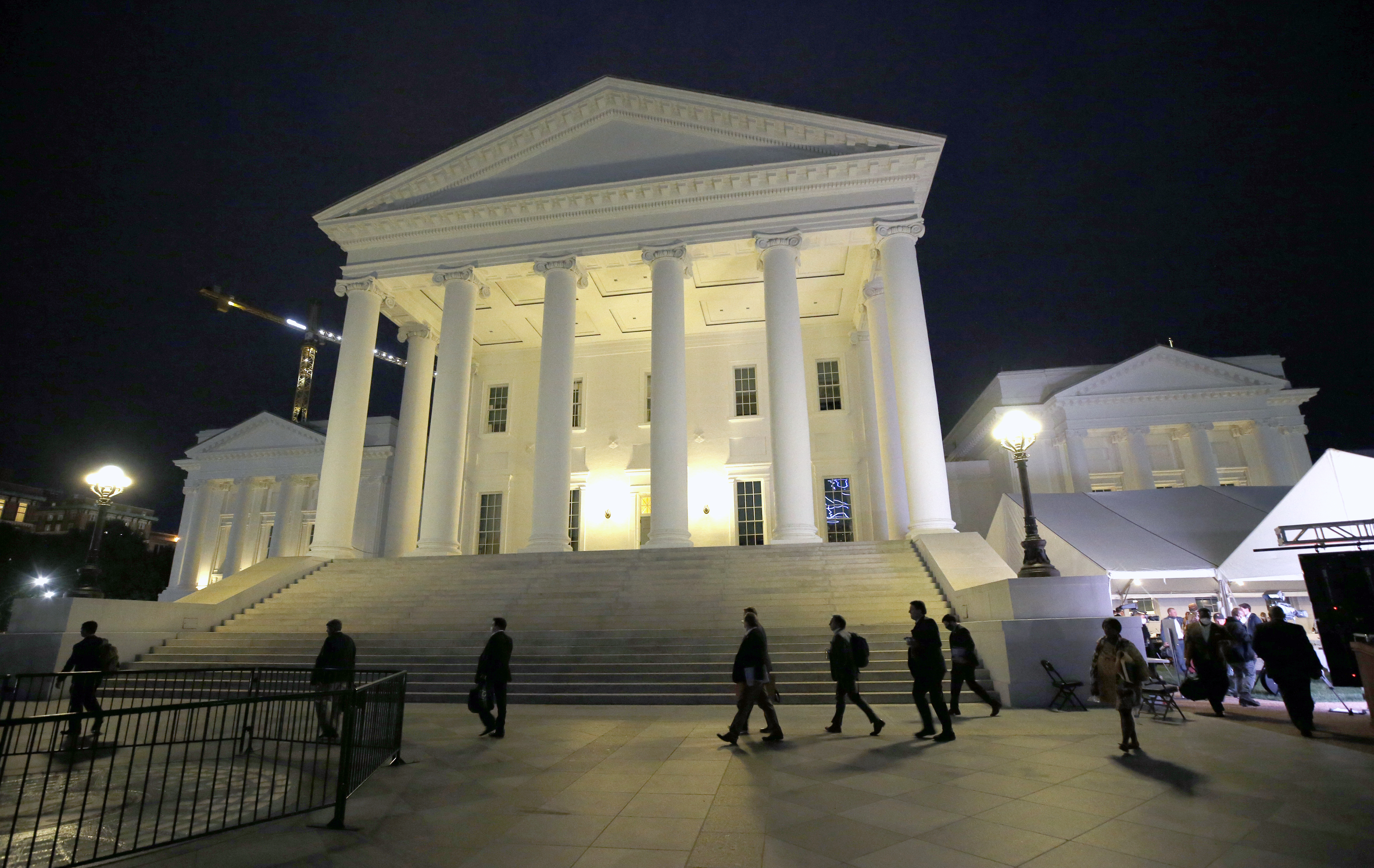 FILE - House of Delegates members walk past the south portico at the Virginia State Capitol in Richmond, Va., Wednesday, April 22, 2020. (Bob Brown/Richmond Times-Dispatch via AP, Pool, File)