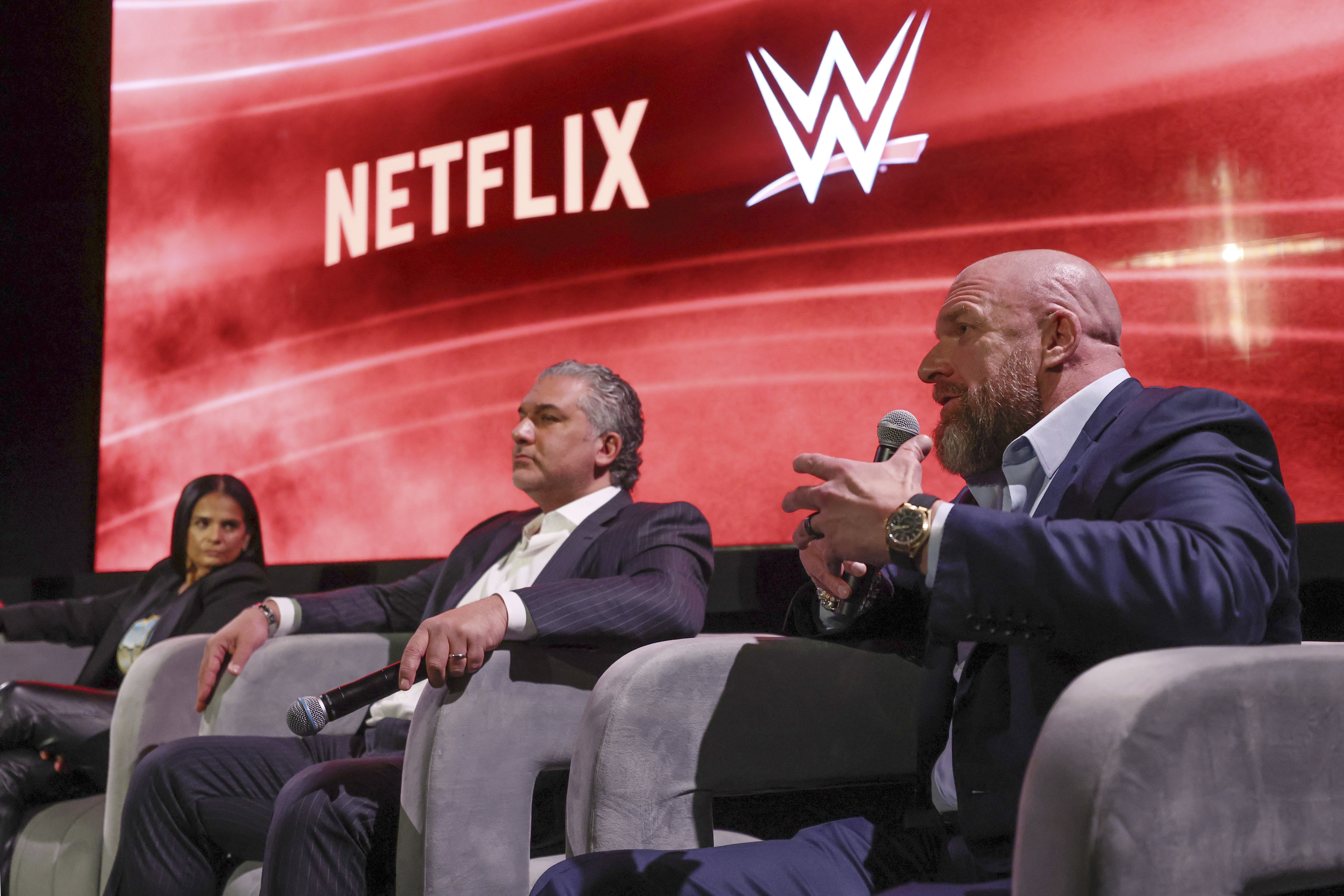 From left, Netflix Chief Content Officer Bela Bajaria, WWE President Nick Khan and WWE Chief Content Officer Paul "Triple H" Levesque discuss the World Wrestling Entertainment and Netflix during an event at Netflix's headquarters in Los Angeles on Dec. 3, 2024. (Meg Oliphant/WWE/Netflix via AP)