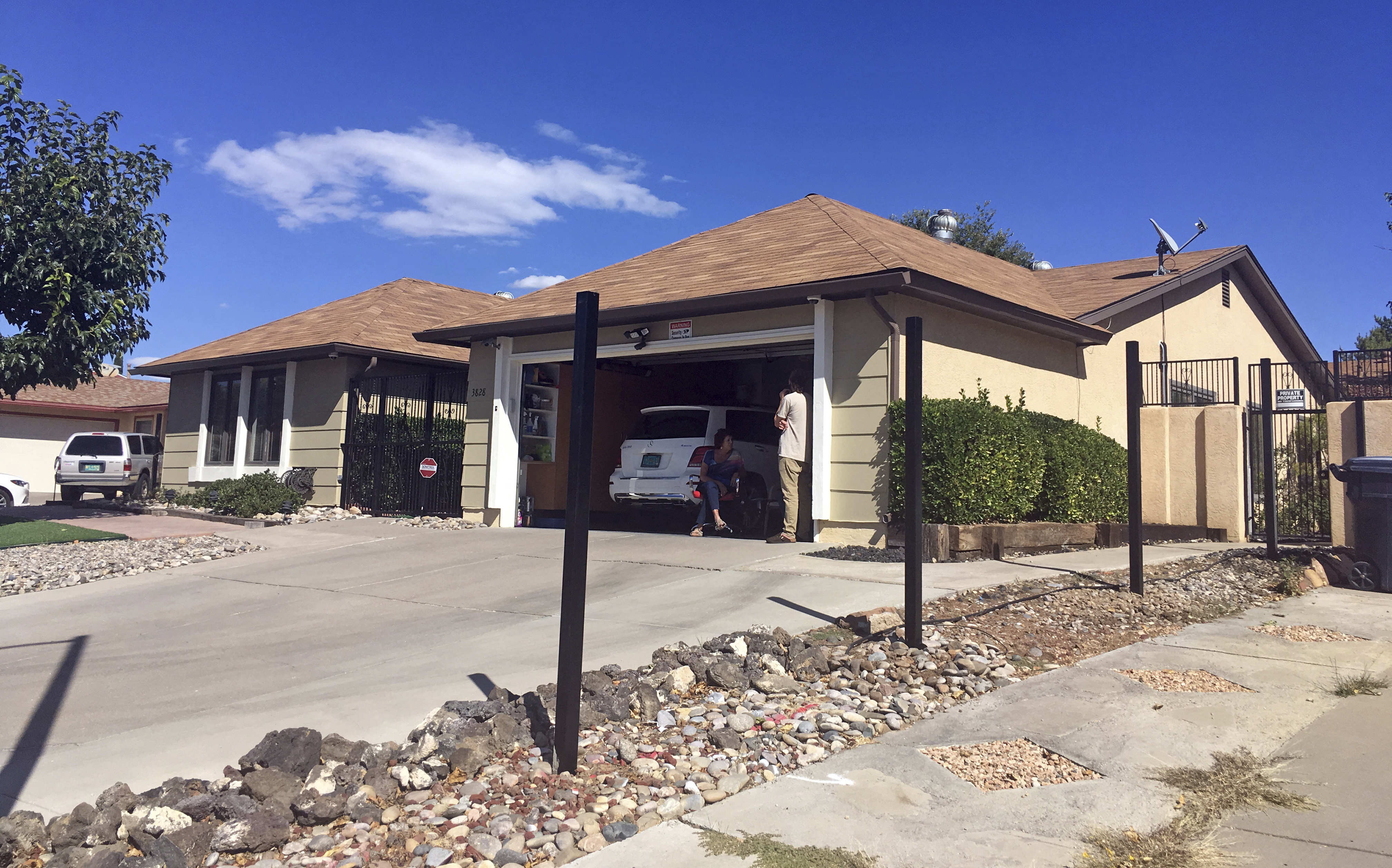 FILE - Poles for a new fence stand outside the house used in the AMC-TV series "Breaking Bad" in Albuquerque, N.M., on Friday, Oct. 13, 2017. (AP Photo/Russell Contreras, File)