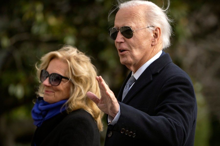 President Joe Biden gestures as he and first lady Jill Biden walk across the South Lawn of the White House, Thursday, Jan. 2, 2025, in Washington, after returning from Camp David. (AP Photo/Mark Schiefelbein)