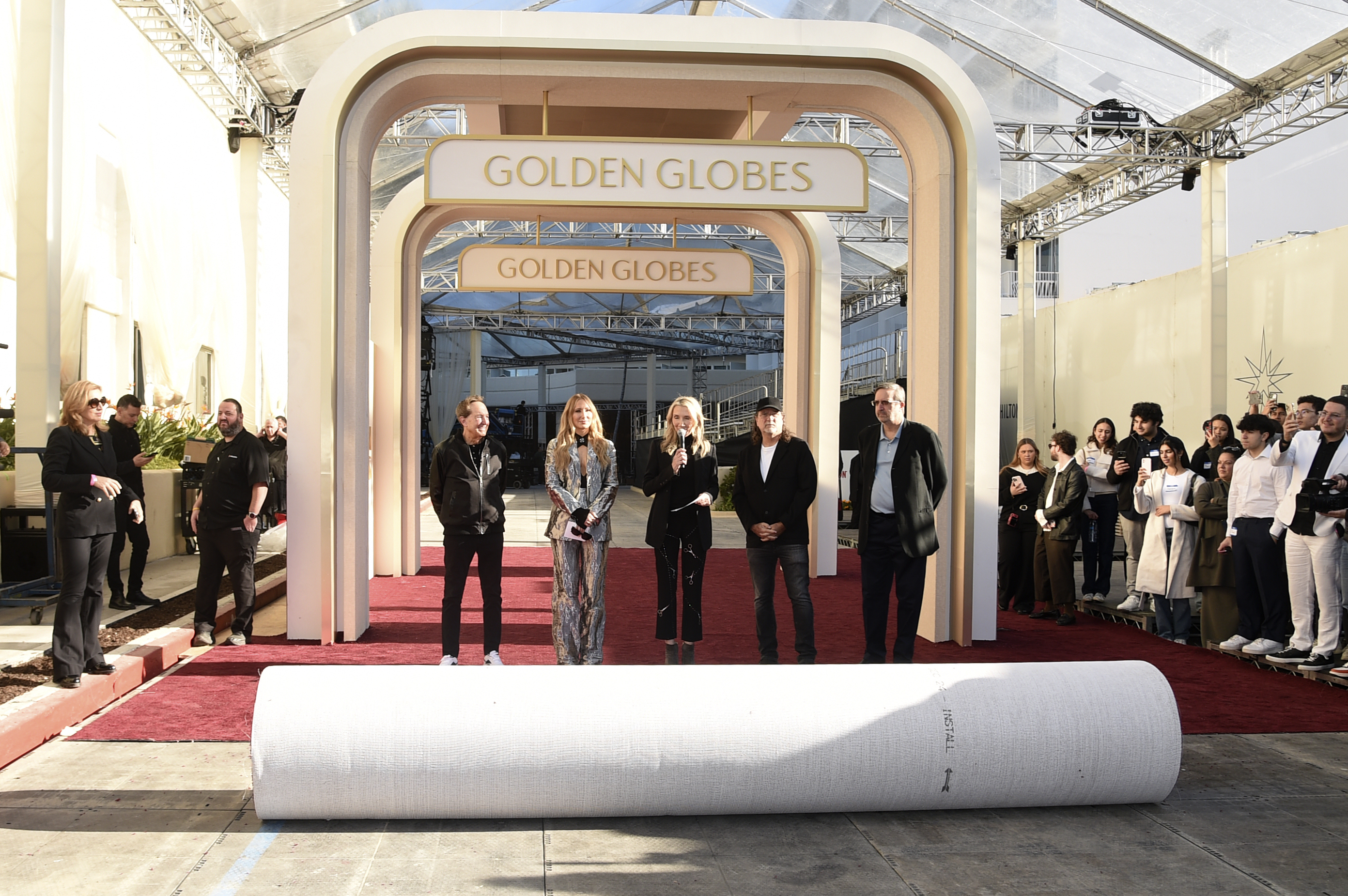 Barry Adelman, from left, Nikki Glaser, Helen Hoehne, Glenn Weiss, and Ricky Kirshner roll out the red carpet during the 82nd Golden Globes press preview on Thursday, Jan. 2, 2025, at the Beverly Hilton in Beverly Hills, Calif. (Photo by Richard Shotwell/Invision/AP)